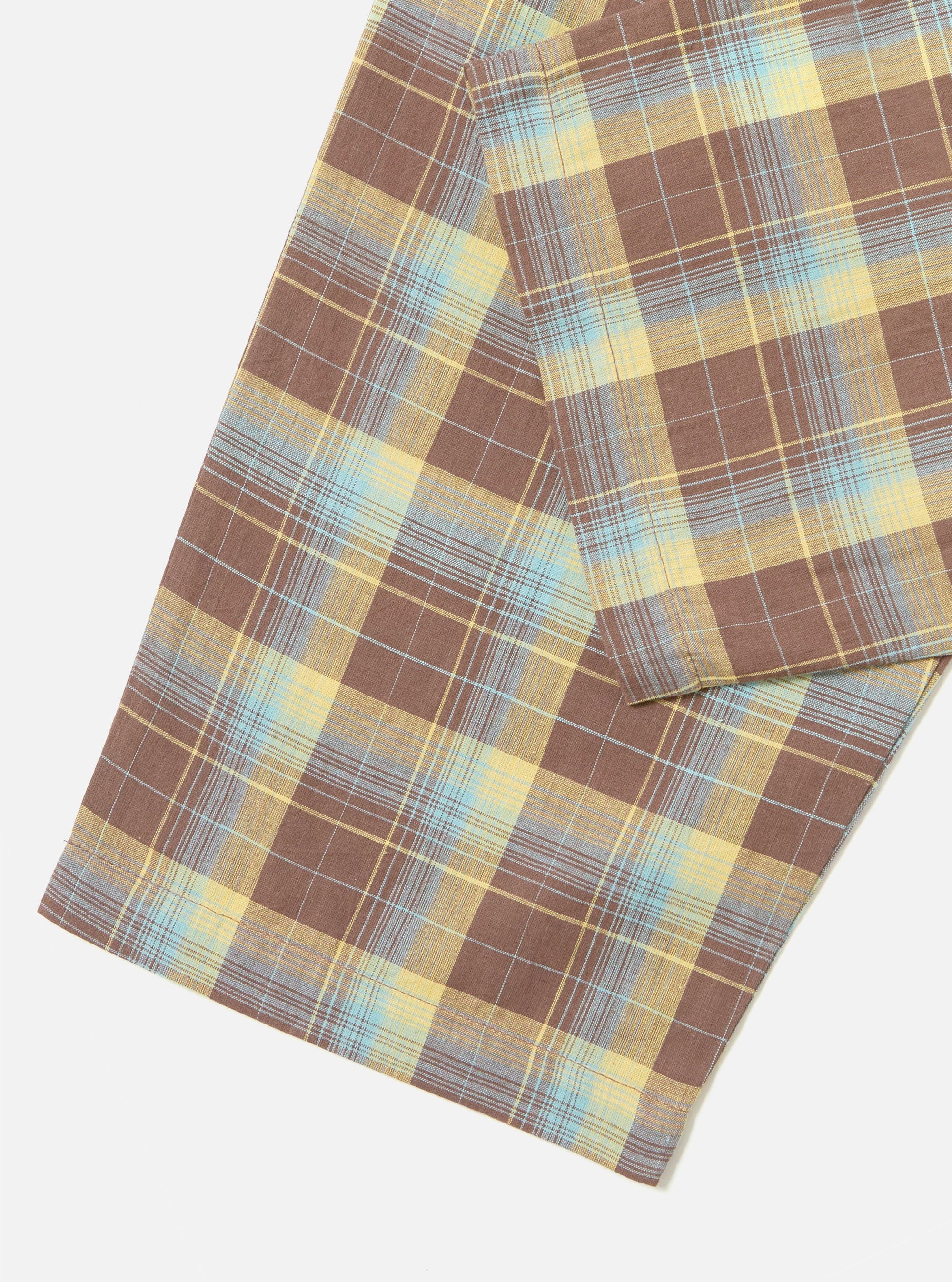 Close-up of the Yellow/Brown Check Pyjama Pant on a white surface. The fabric features a brown, yellow, and blue plaid pattern.