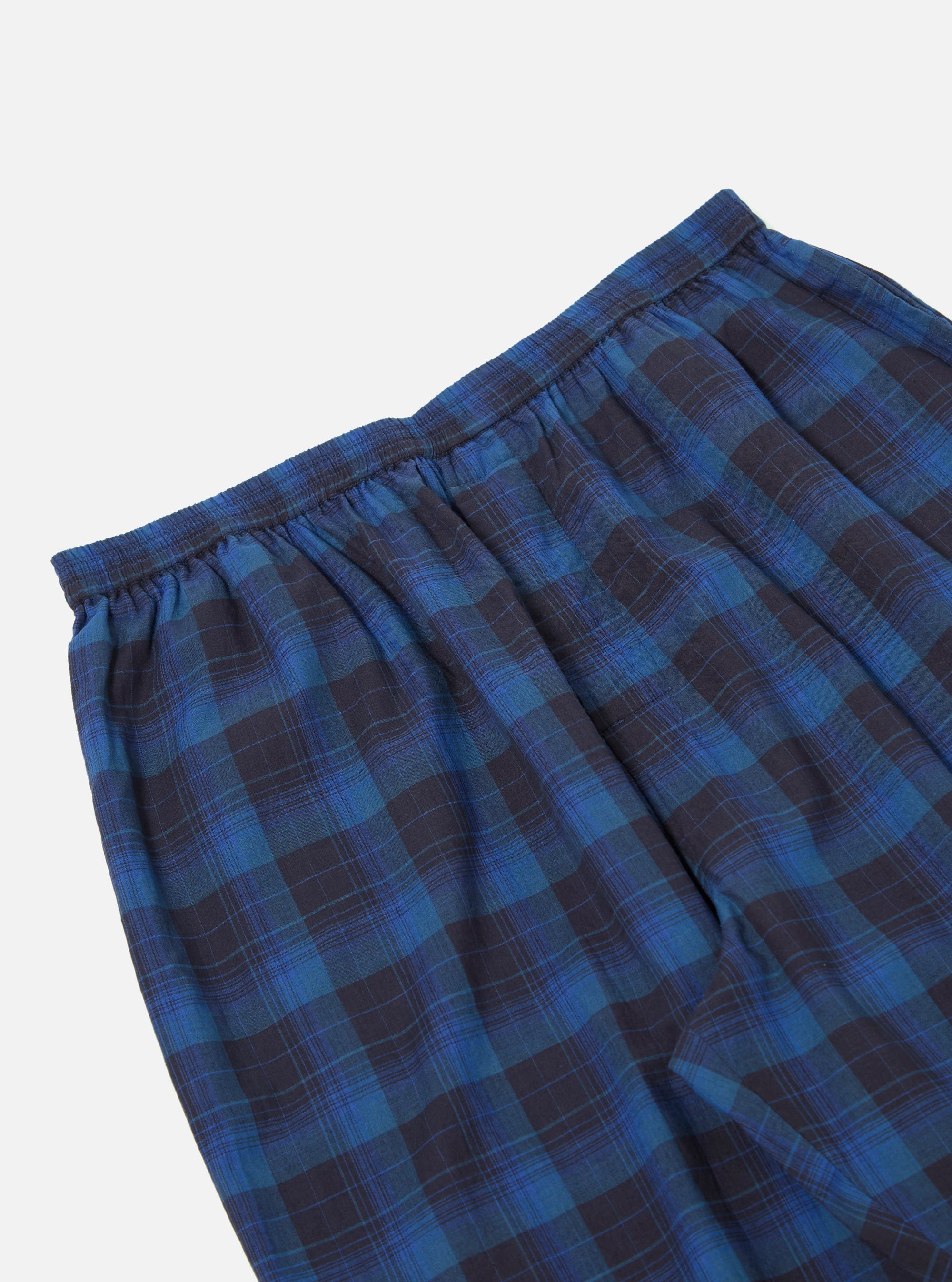 Close-up of the Navy/Blue Check Pyjama Pant on a white background. The fabric is a soft, brushed cotton with a classic plaid pattern. Elastic waistband detail.
