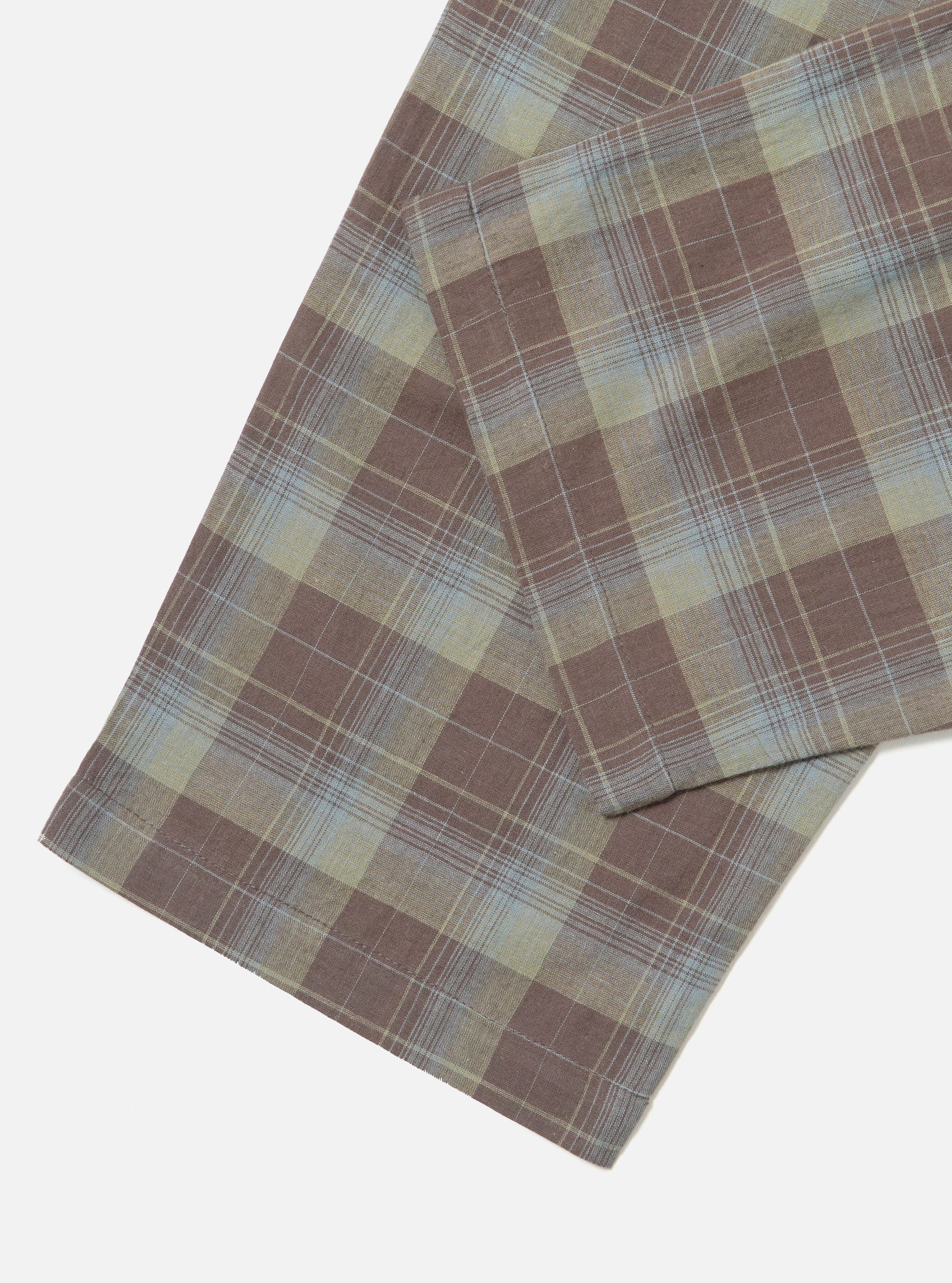 Close-up of the Green/Brown Check Pyjama Pant on a white surface. The fabric features a classic plaid pattern with green, brown, and light blue hues.