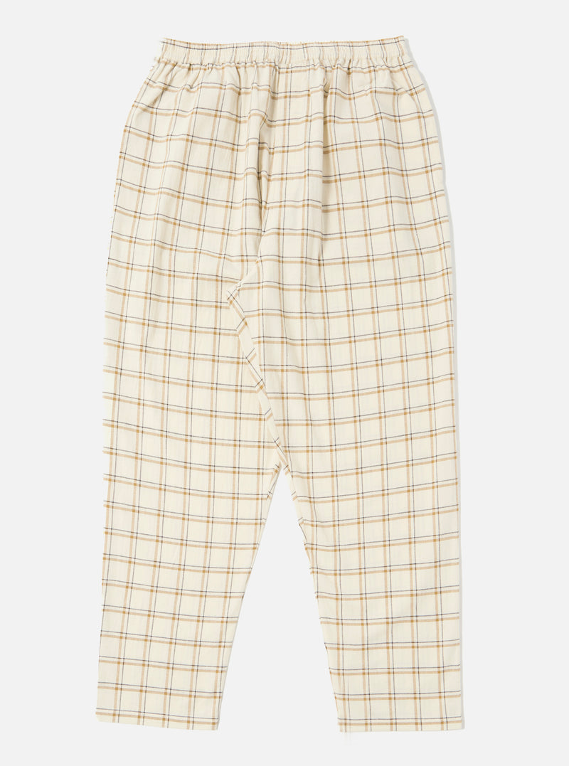 Close-up of the Ecru PJ Plaid Pyjama Pant on a white background. The pants are ecru with a brown and grey plaid pattern and an elastic waistband.