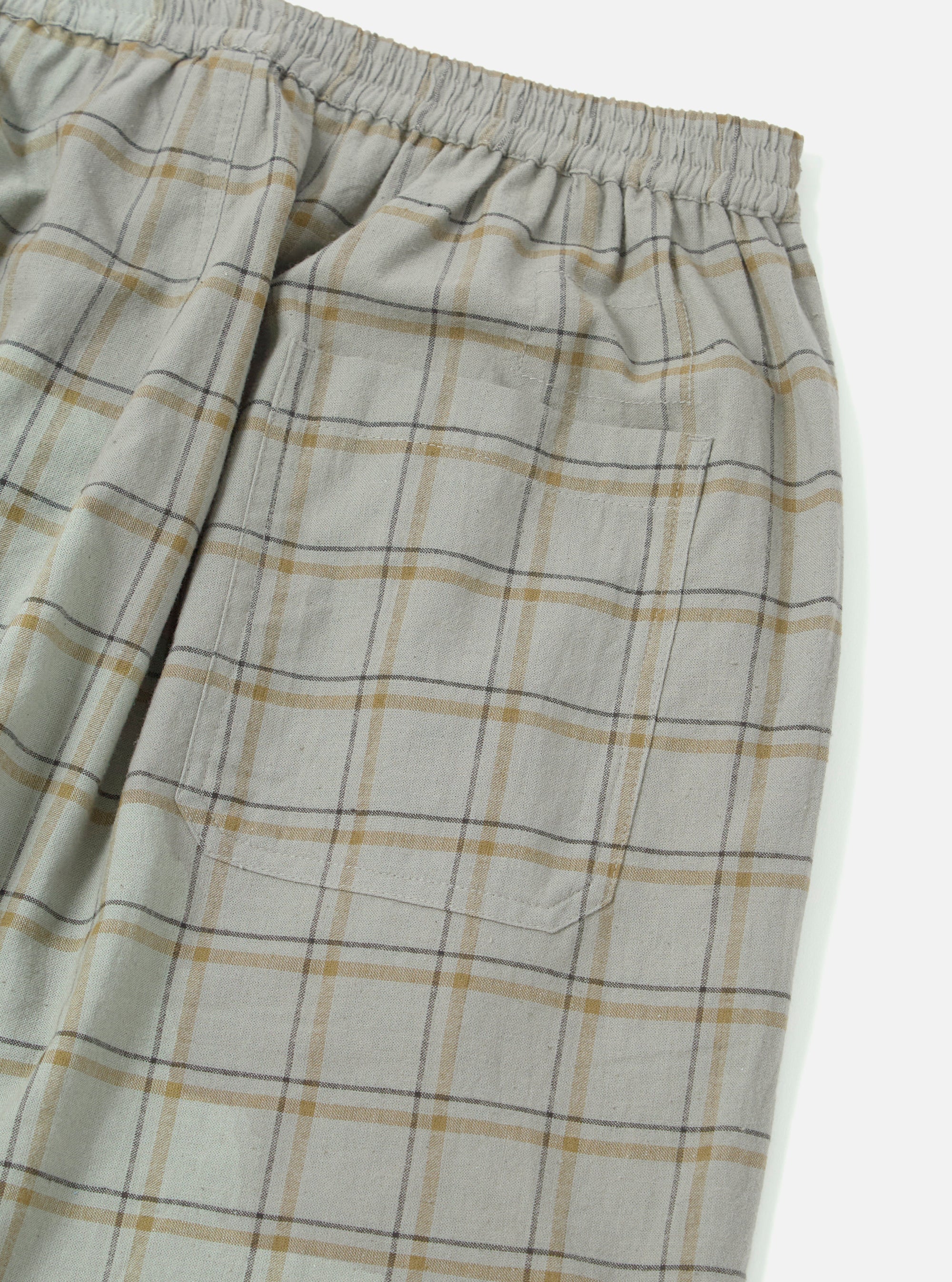 Close-up of the Green PJ Plaid Pyjama Pant on a white background. The fabric is a soft, brushed cotton with a green, gold, and brown plaid pattern. Features an elastic waistband and a pocket.