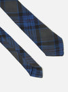 Close-up of a Navy Ikat Twill Check Tie on a white background. The tie features a blue and black check pattern.