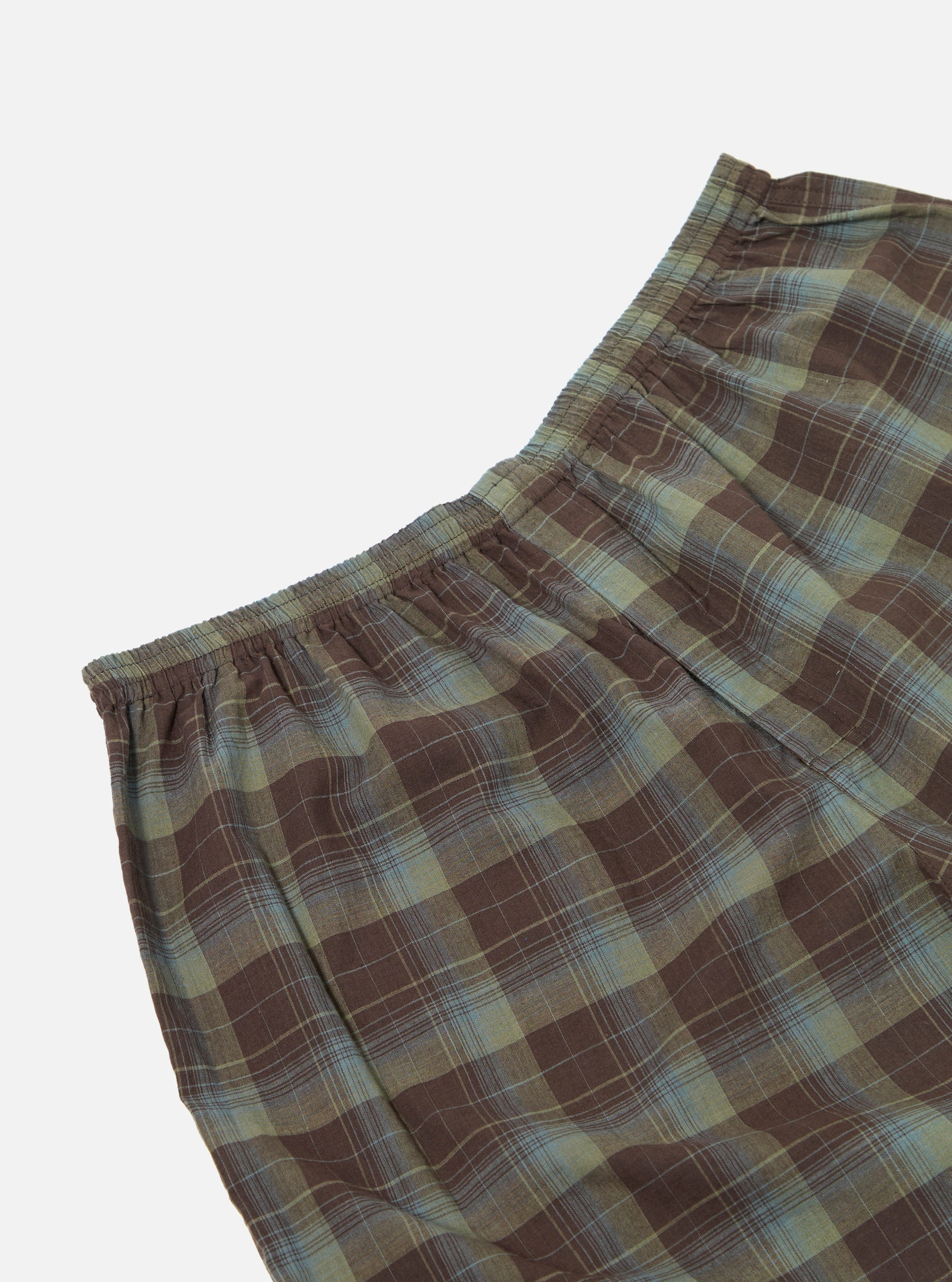 Close-up of Green Patchwork Madras Boxer Short on a white background. The fabric is a brown and green plaid with an elastic waistband.