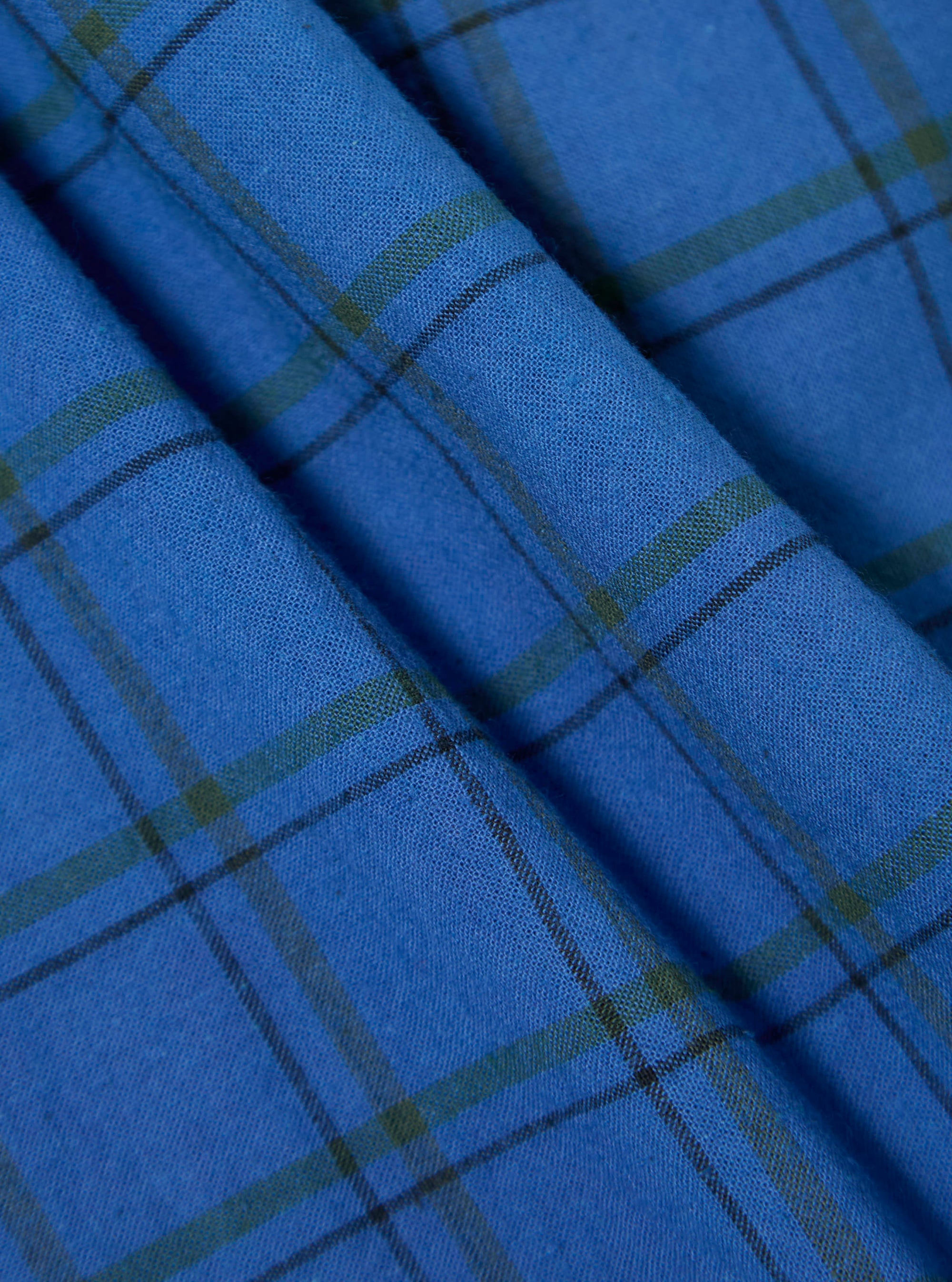 Close-up of the blue plaid fabric of the Navy PJ Plaid Boxer Short. The material is folded, showing the texture and pattern of the fabric.