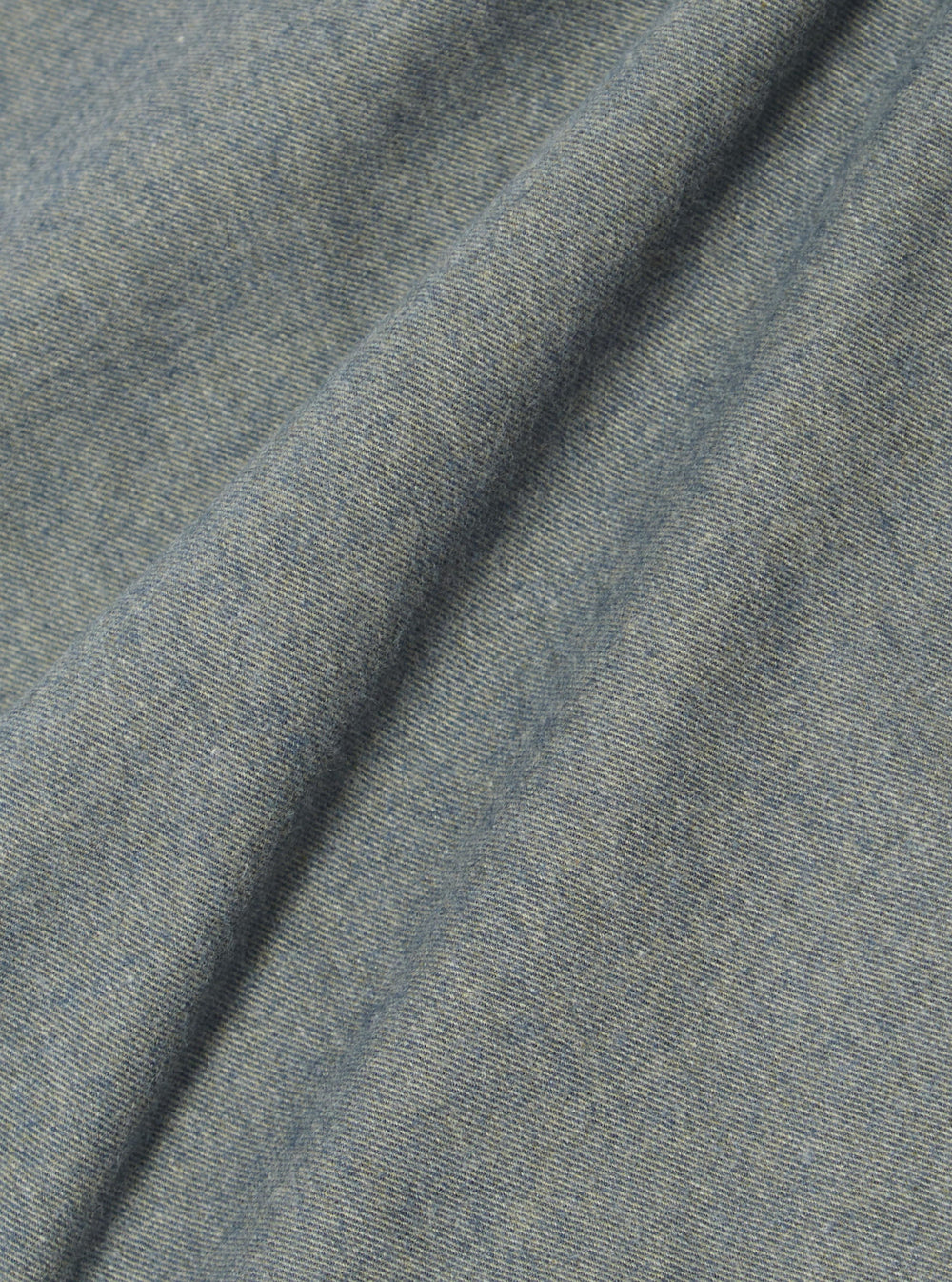 Close-up of the soft, brushed flannel fabric of the Navy Brushed Flannel Work Shirt. The material is a light navy color and has a subtle texture.