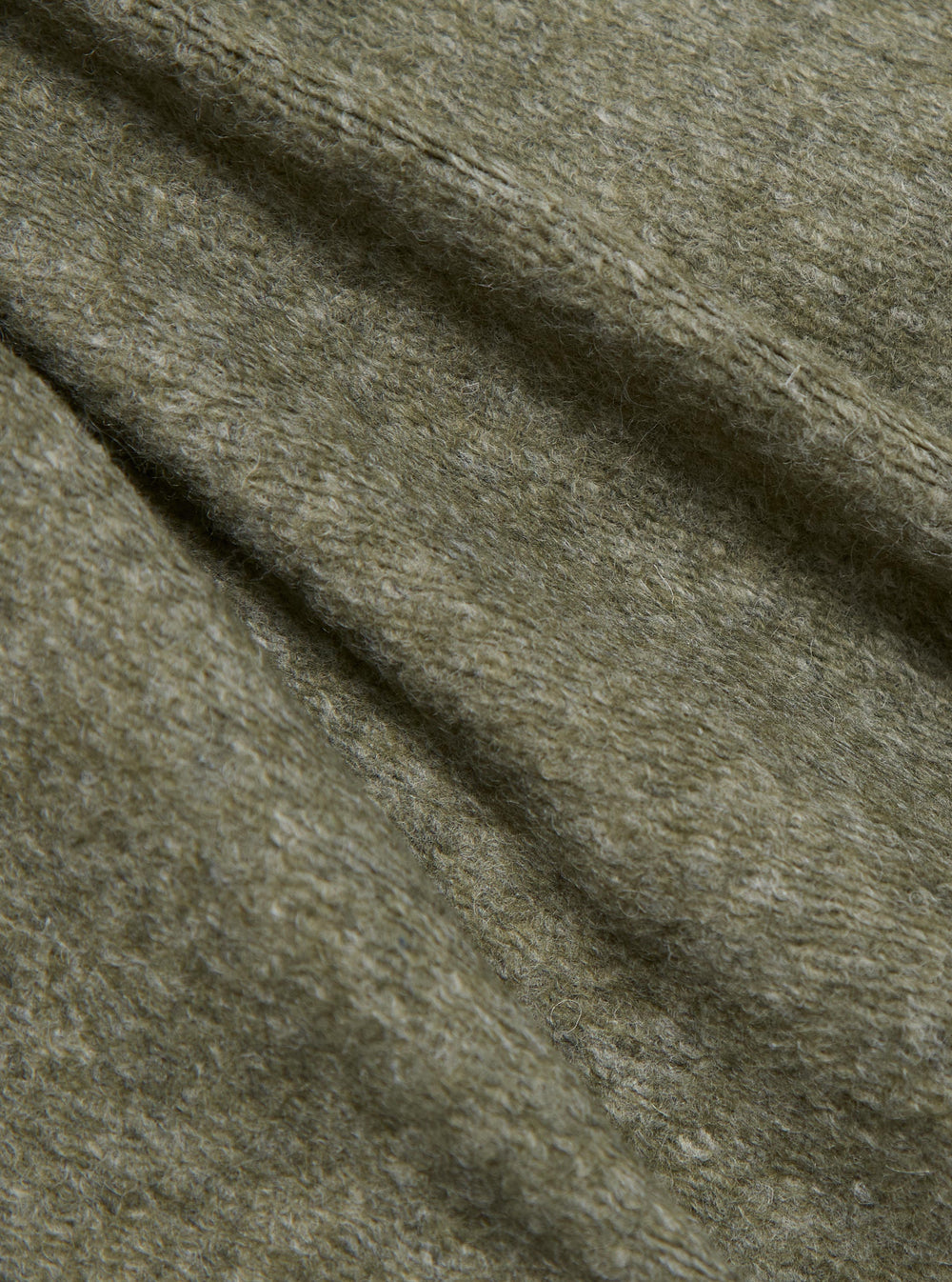 Close-up of the Pale Green Dam Marl Work Shirt fabric. The soft, textured material is draped to show its color and weave. Studio shot.