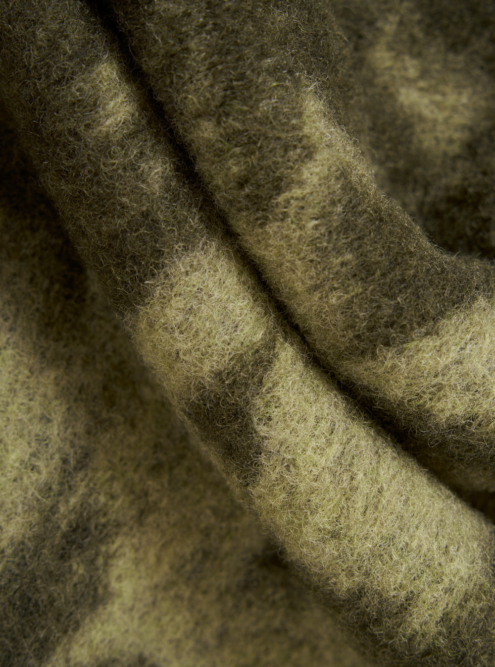 Close-up of the Green/Pale Green Studio Fleece Zip Liner Jacket. The soft, textured fabric is draped to show its color and material. The background is plain.