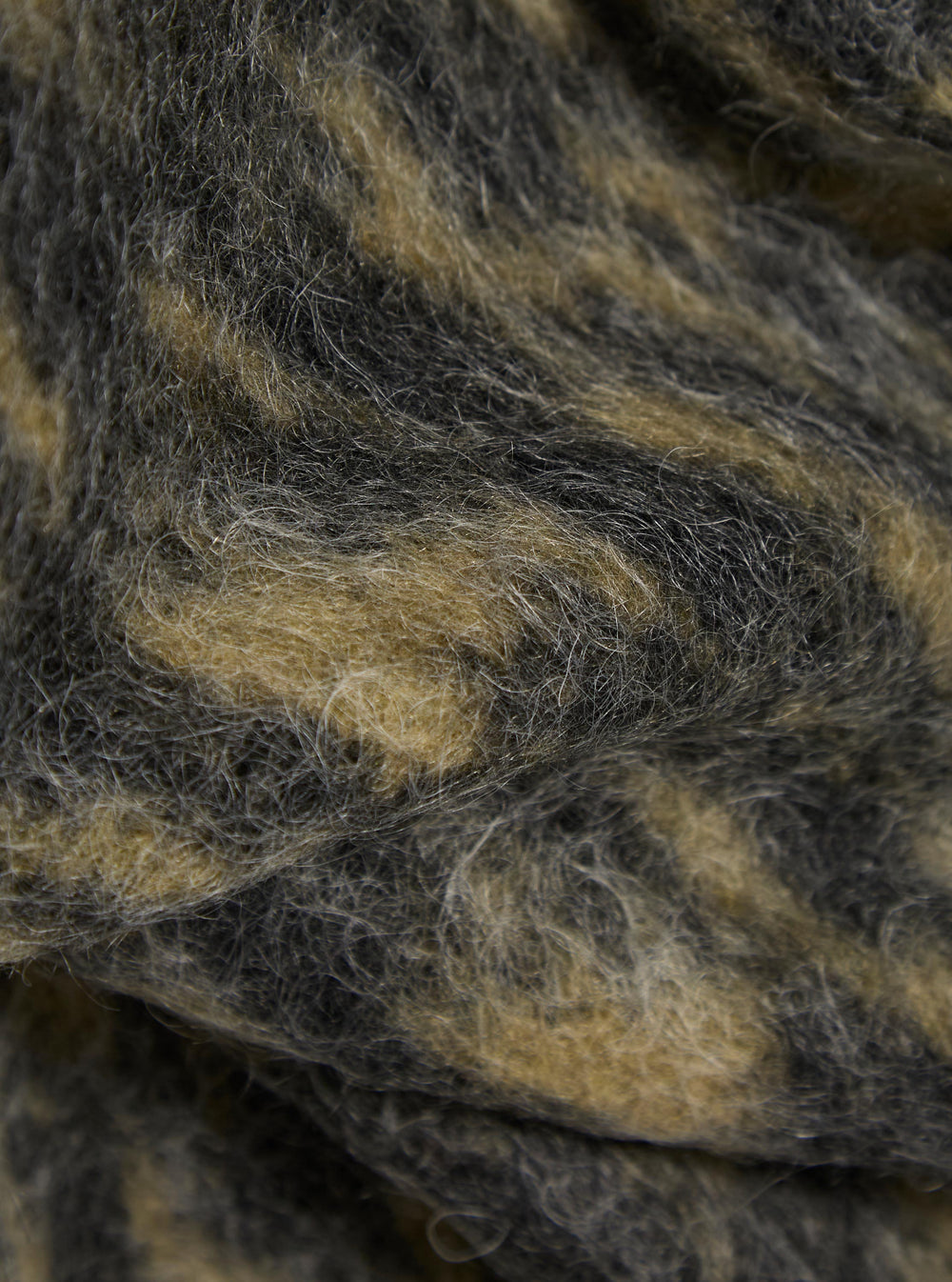 Close-up of the Charcoal Dolce Fleece Cardigan, showing the soft, textured material in shades of charcoal and cream. The fleece has a plush, inviting look.