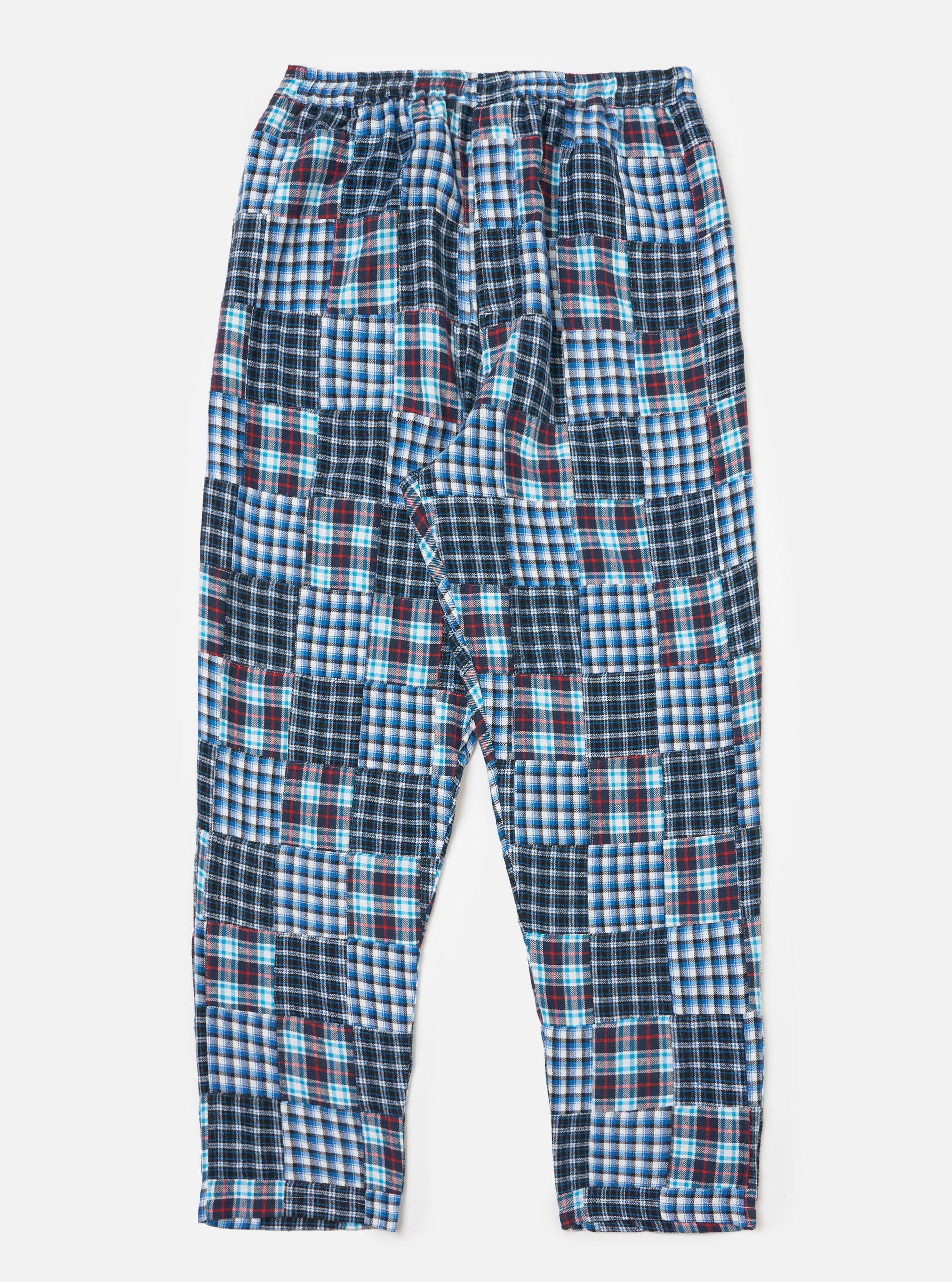 The Blue Brushed Patchwork Pyjama Pant on a white background. These cotton pants feature a blue, white, and red patchwork design and a relaxed fit.