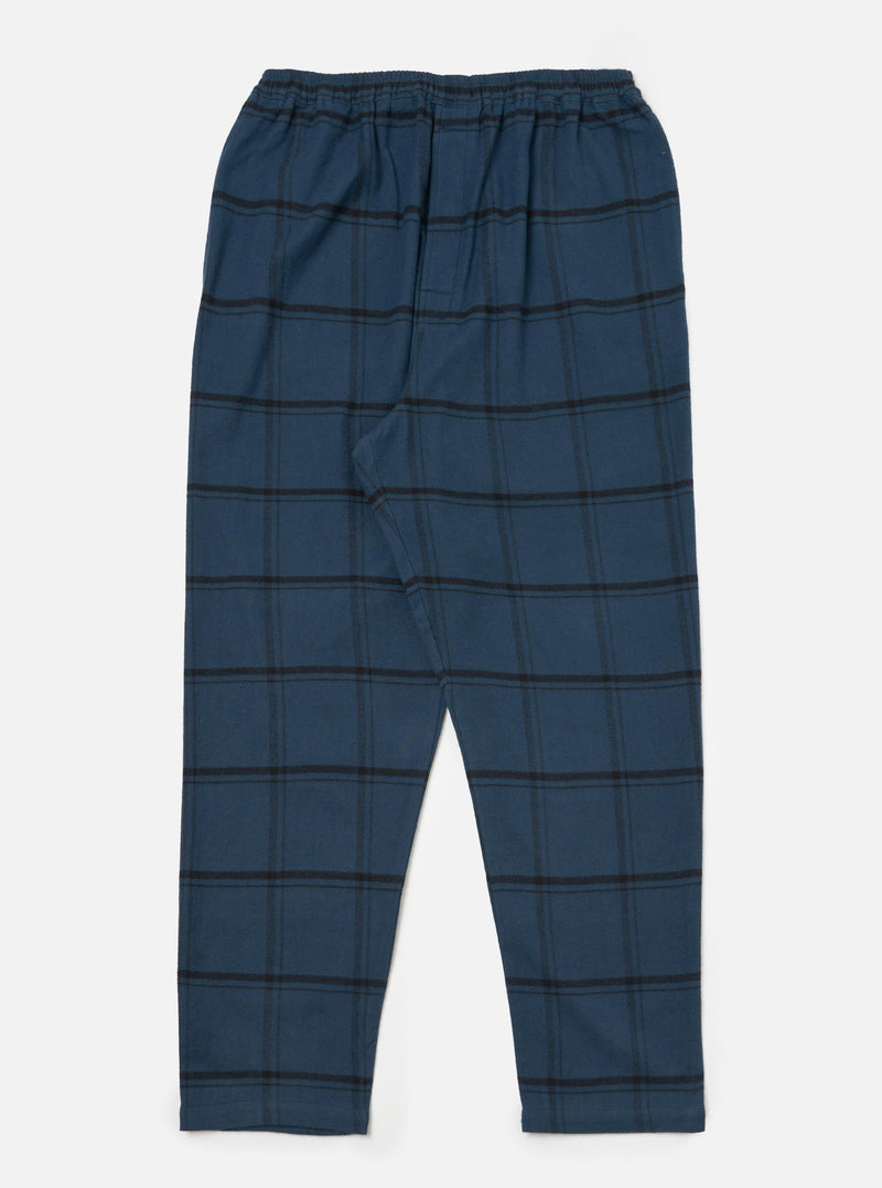 The Blue Brushed Check Pyjama Pant, laid flat on a white surface. The pants are blue with a black check pattern and an elastic waistband.