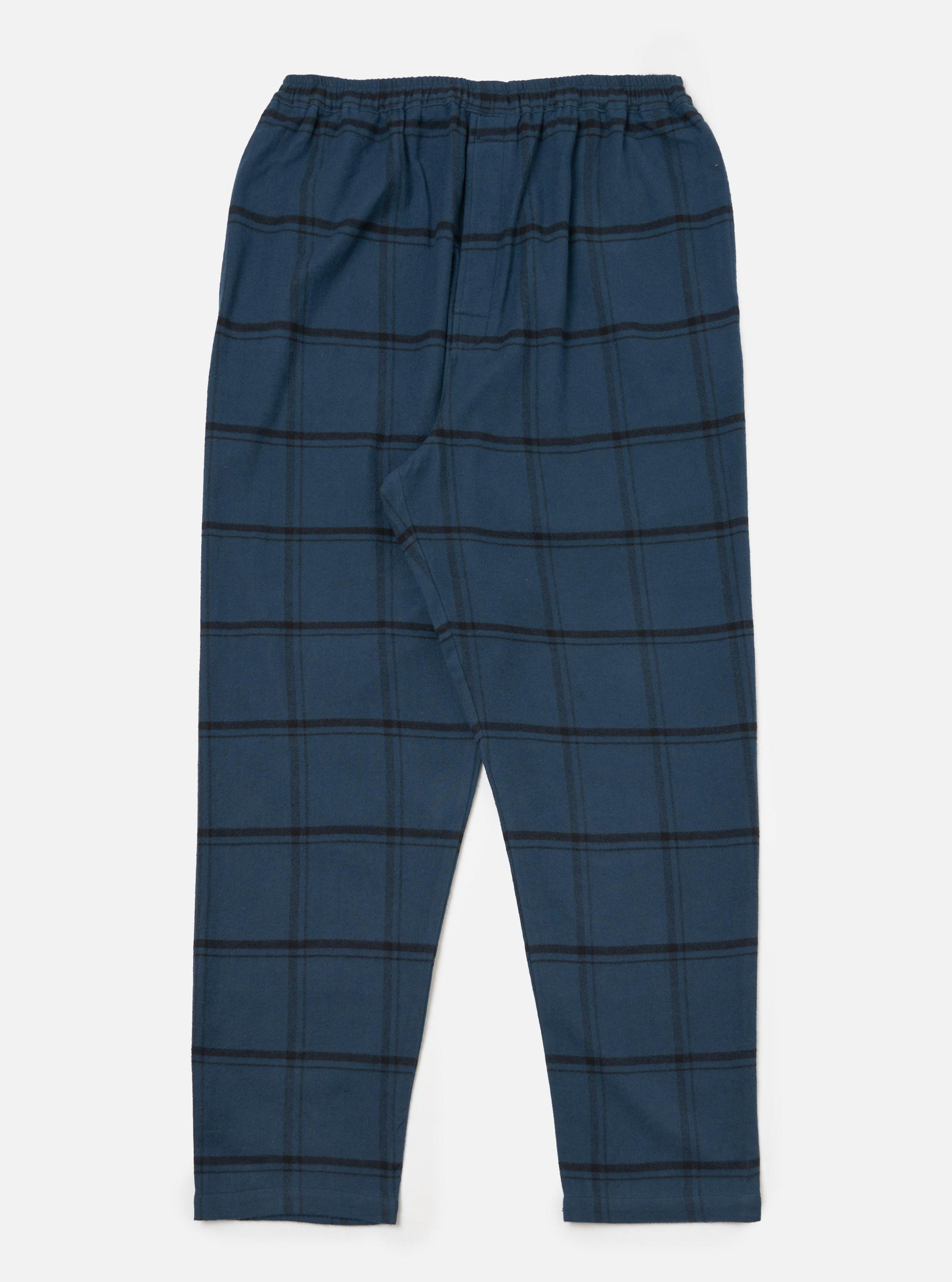 The Blue Brushed Check Pyjama Pant, laid flat on a white surface. The pants are blue with a black check pattern and an elastic waistband.
