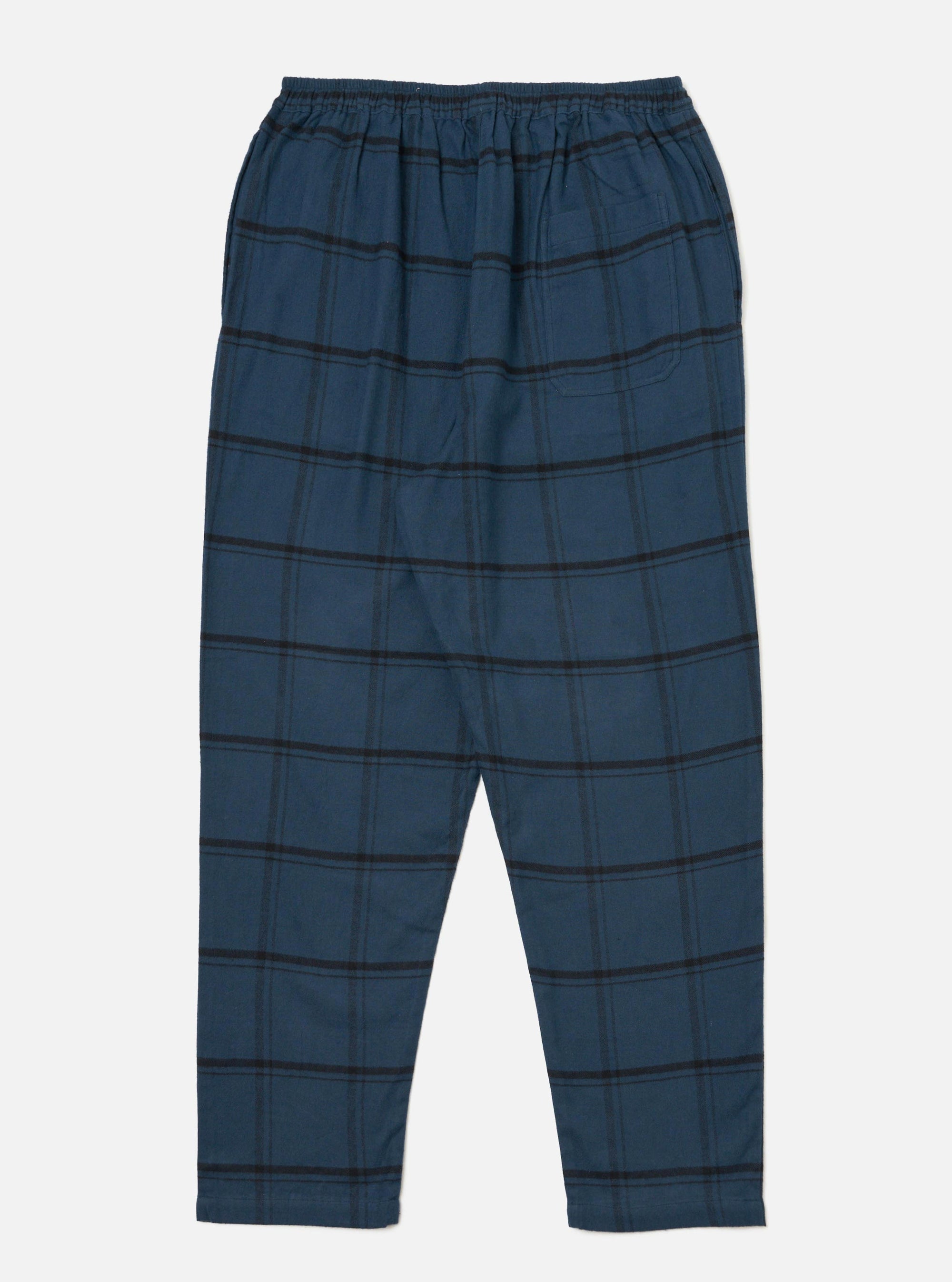The Blue Brushed Check Pyjama Pant on a white background. The pants are blue with a black check pattern and have an elastic waistband.