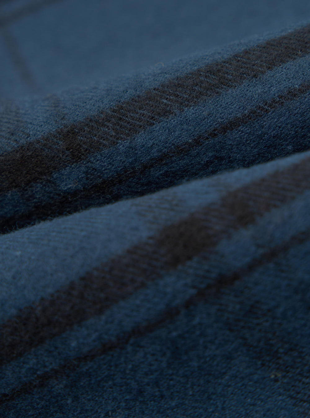 Close-up of the soft, brushed texture of the Blue Brushed Check Pyjama Pant. The fabric features a classic blue and black check pattern.