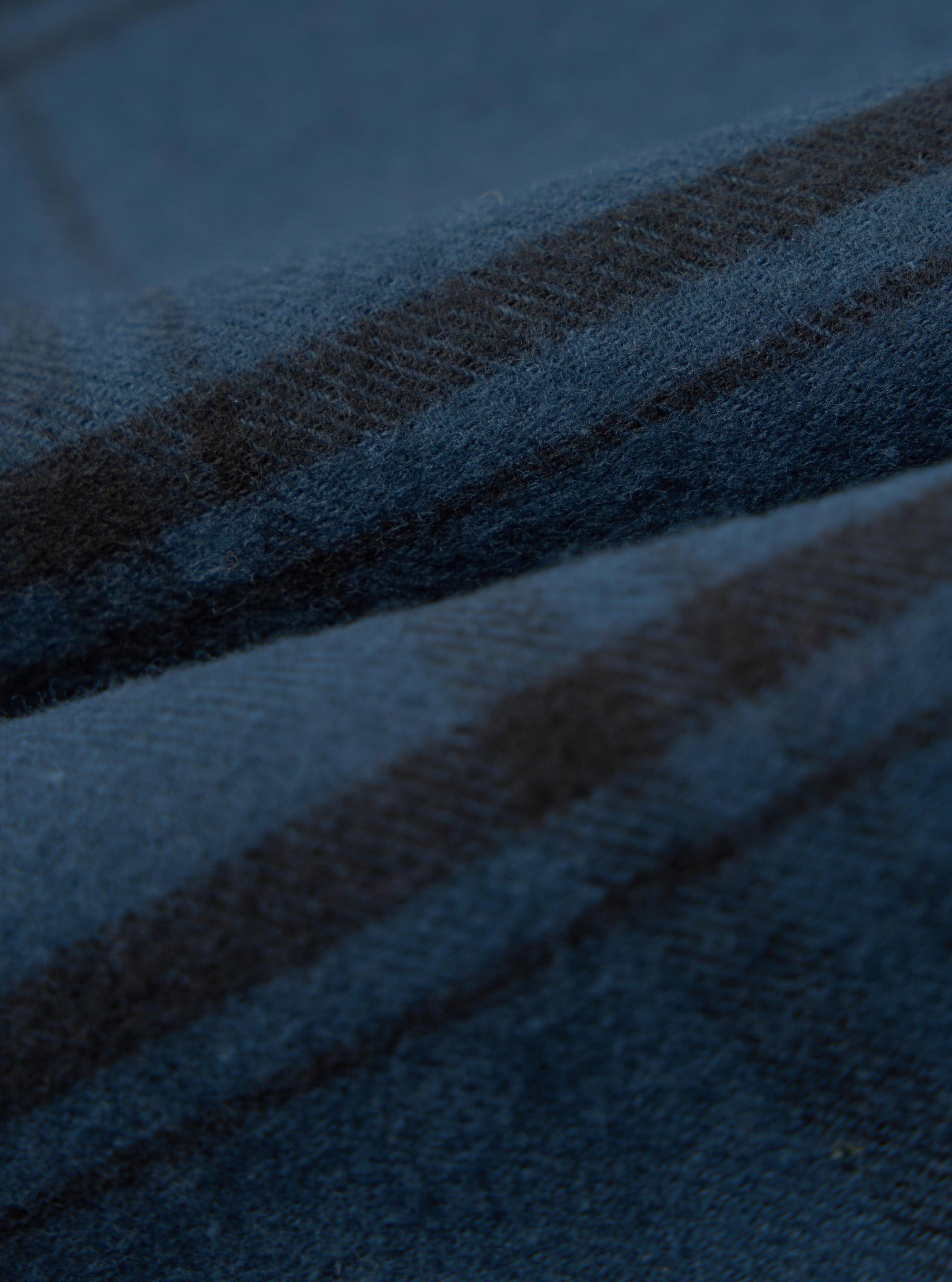 Close-up of the soft, brushed texture of the Blue Brushed Check Pyjama Pant. The fabric features a classic blue and black check pattern.