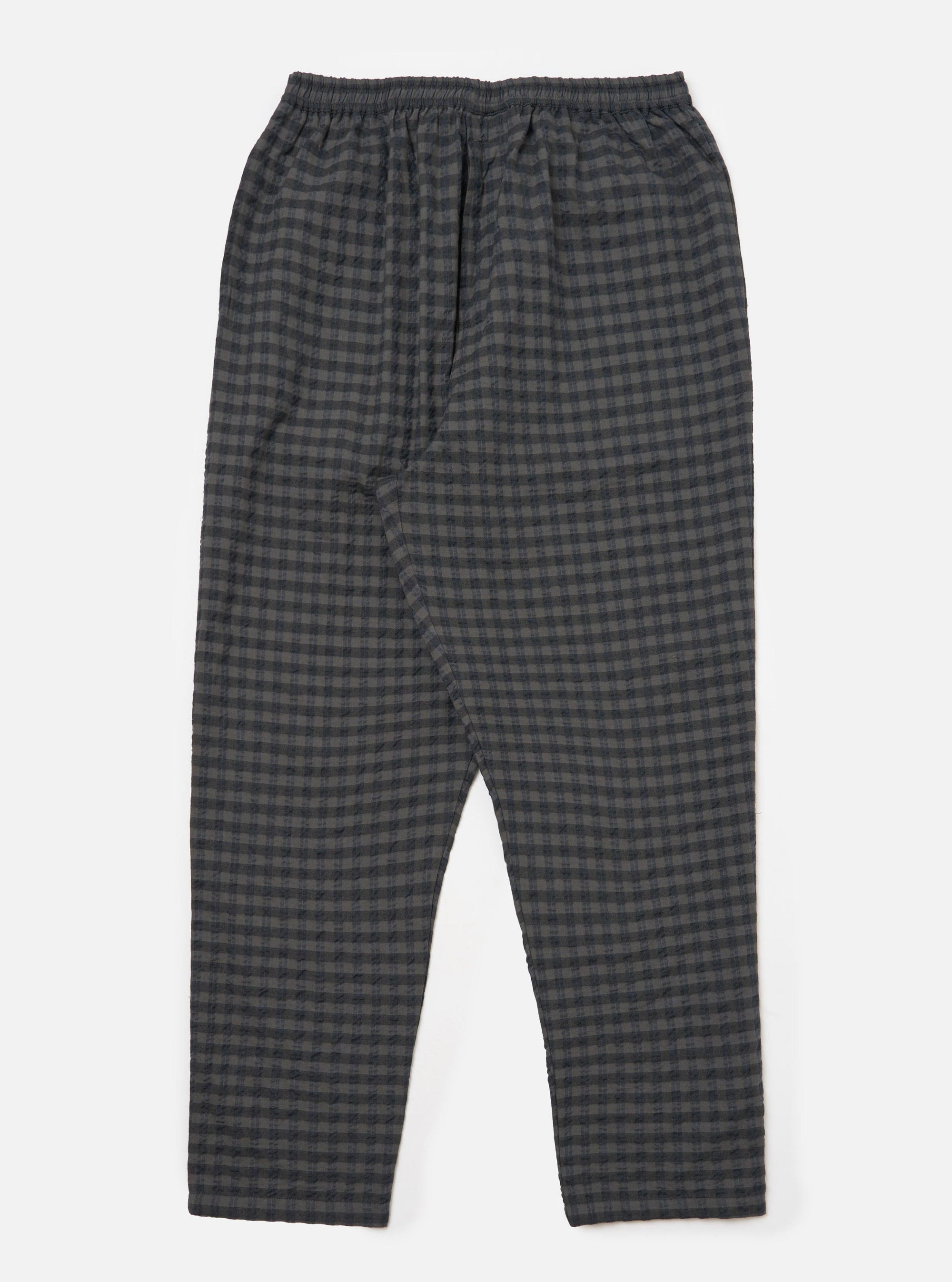 The Charcoal/Navy Seersucker Plaid Pyjama Pant on a white background. The pants have an elastic waist and a relaxed fit. The material is a textured plaid in charcoal and navy.