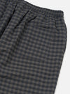 Close-up of the Charcoal/Navy Seersucker Plaid Pyjama Pant on a white background. Shows the elastic waist and back pocket. The fabric is a textured plaid.