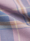 Close-up of the Pink/Blue Pastel Plaid Pyjama Pant fabric. Soft pastel pink, blue, and beige plaid pattern. The fabric is folded, showing the texture.