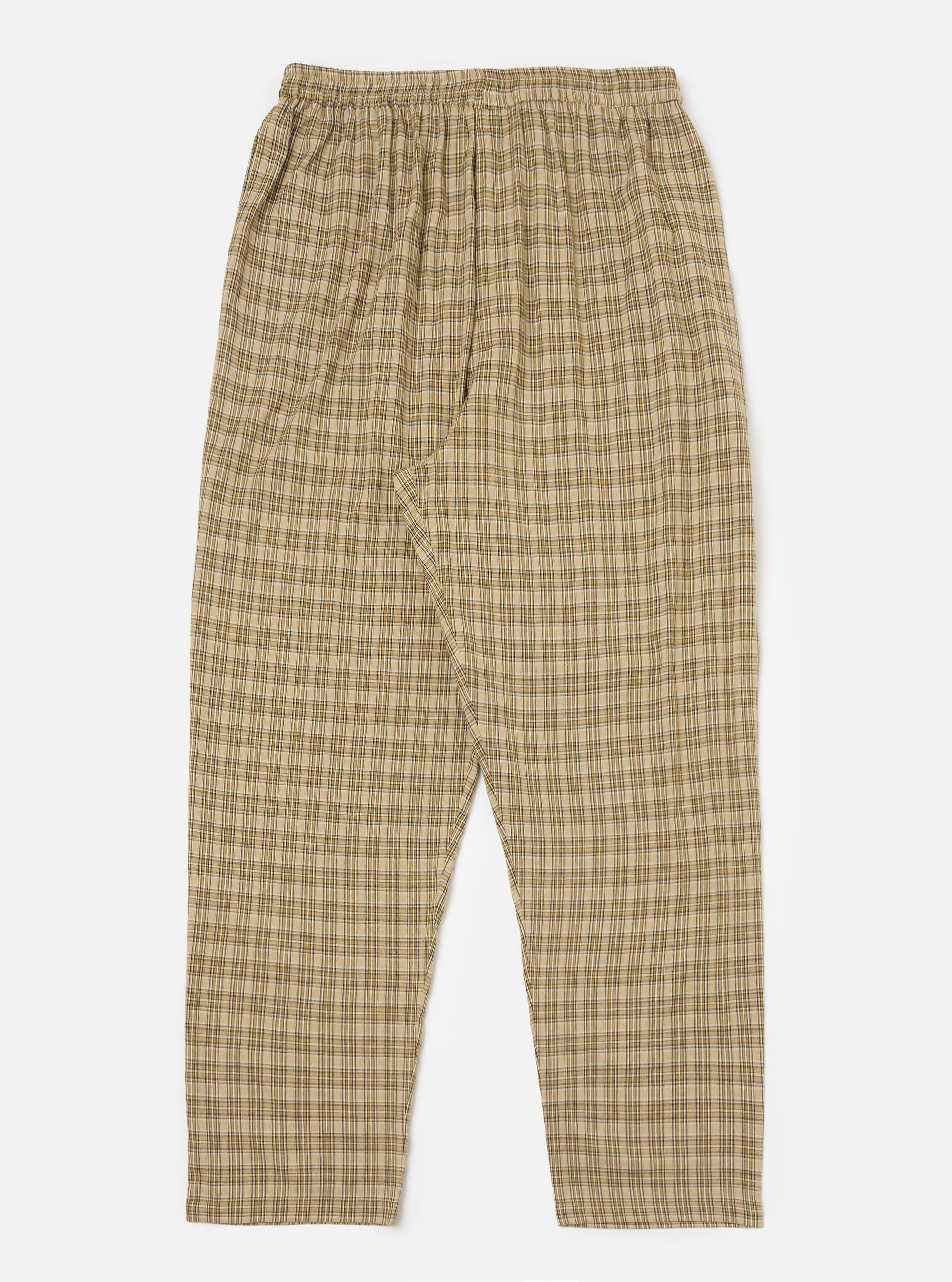 The Sand Picnic Plaid Pyjama Pant, displayed on a white background. The pants are a loose fit, with a beige, brown, and white plaid pattern and an elastic waistband.