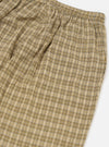 Close-up of the Sand Picnic Plaid Pyjama Pant. Features a beige, white, and brown plaid pattern. Elastic waistband. Shot on a white background.