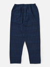 Close-up of the Indigo Plaid Long Pyjama Set pants on a white background. The pants are blue with a light blue plaid pattern and have an elastic waistband.