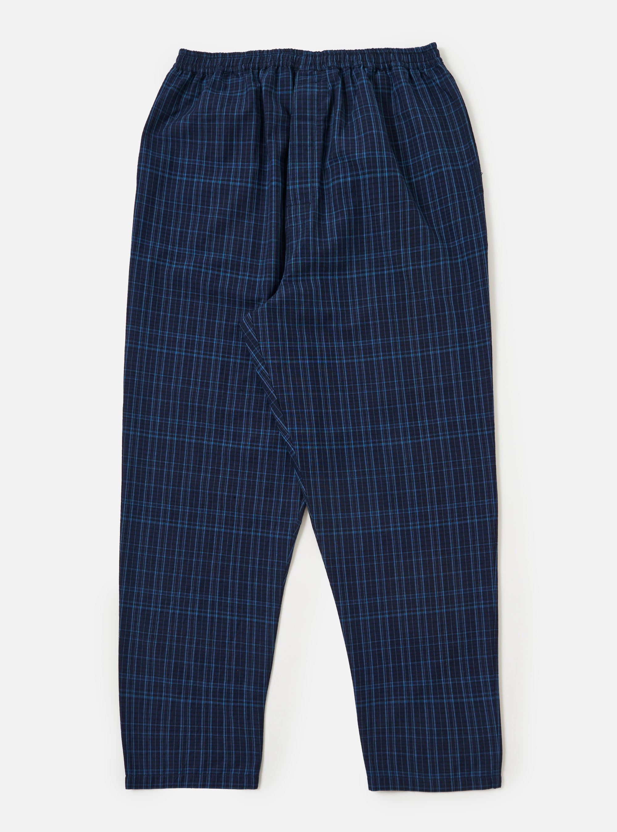 Close-up of the Indigo Plaid Long Pyjama Set pants on a white background. The pants are blue with a light blue plaid pattern and have an elastic waistband.