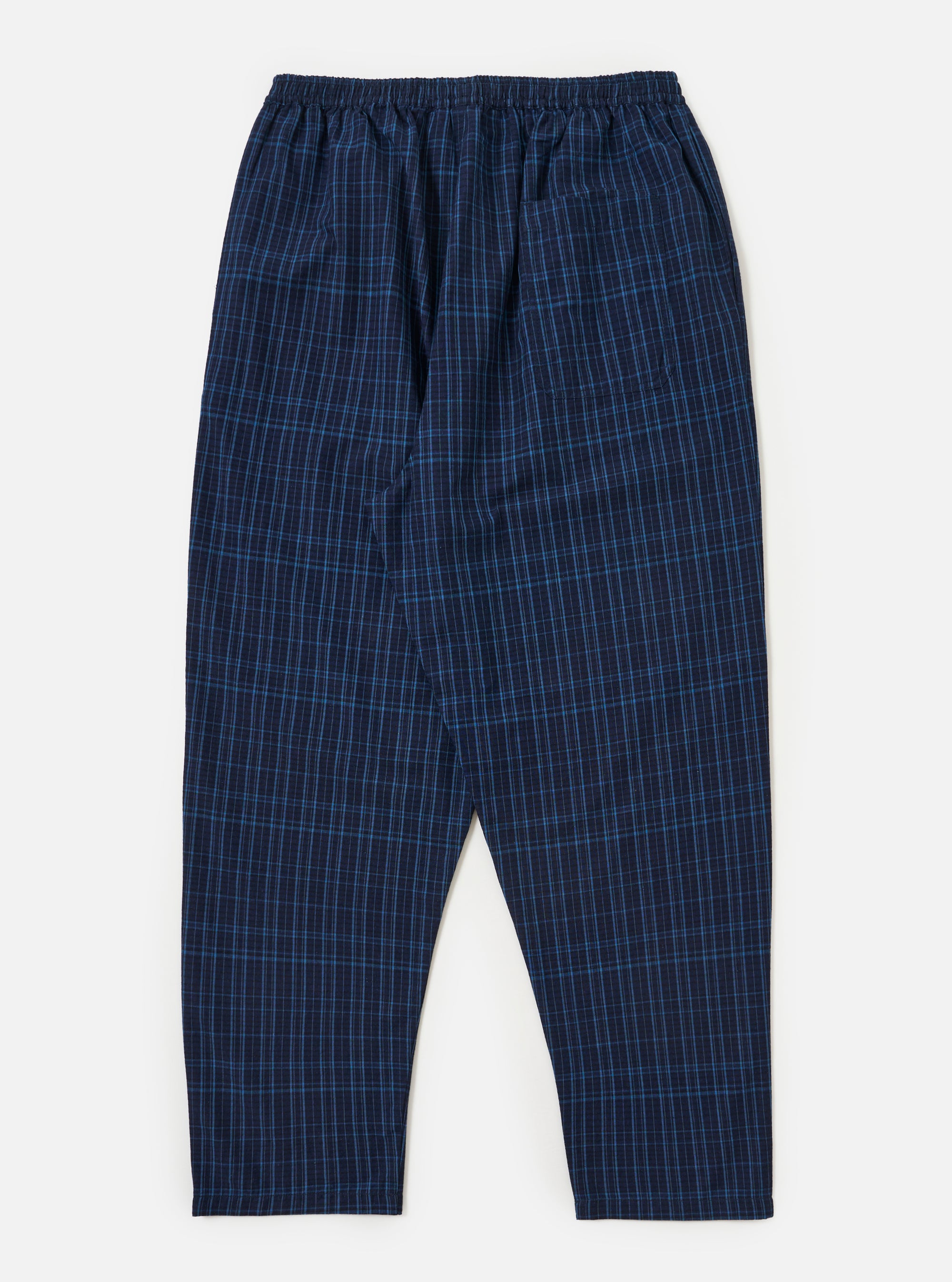 The Indigo Plaid Long Pyjama Set pants laid flat on a white background. The pants are a blue plaid pattern with an elastic waistband.