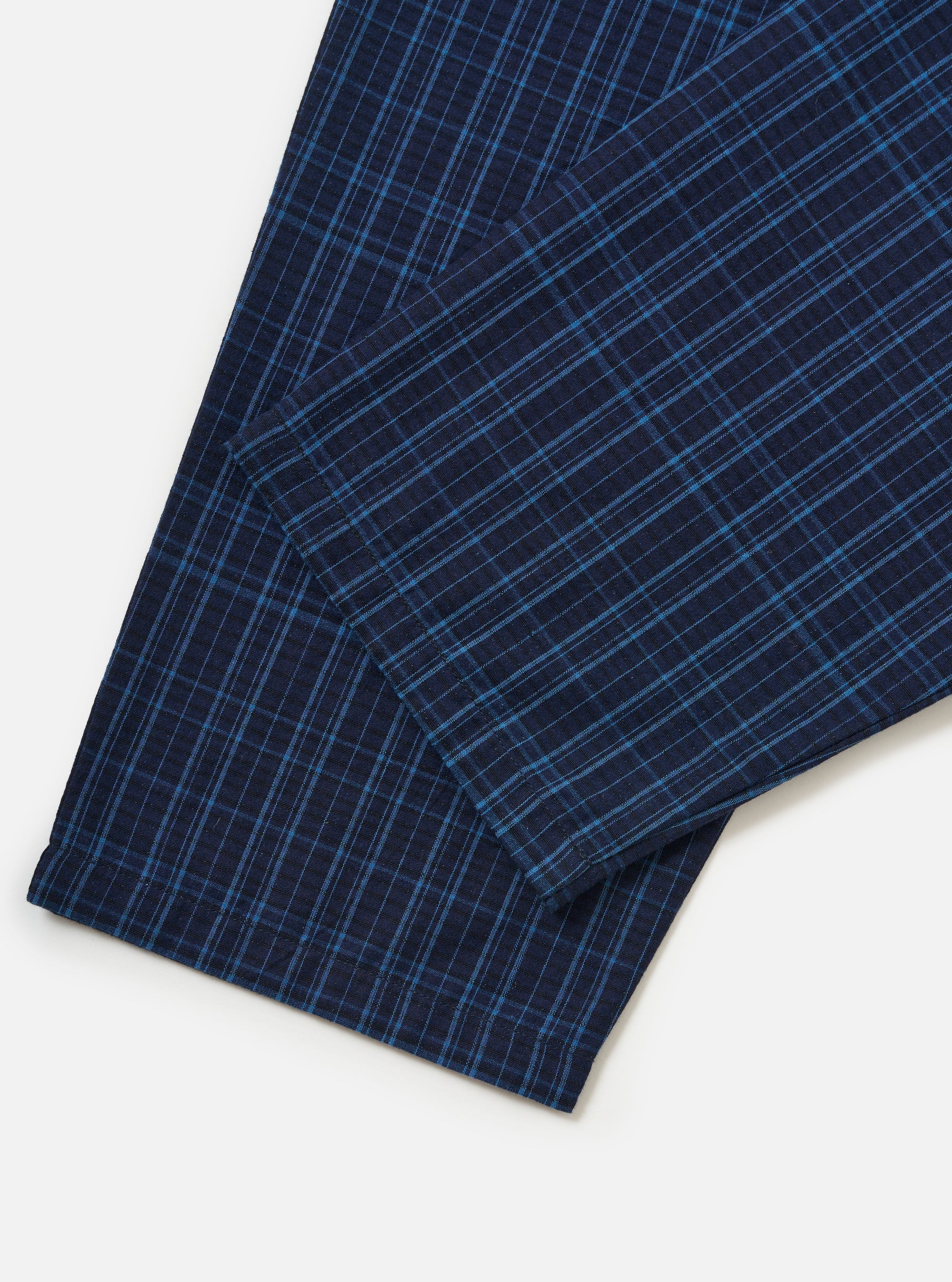 Close-up of the Indigo Plaid Long Pyjama Set. The fabric is a soft cotton blend with a classic blue plaid pattern, laid on a clean white surface.