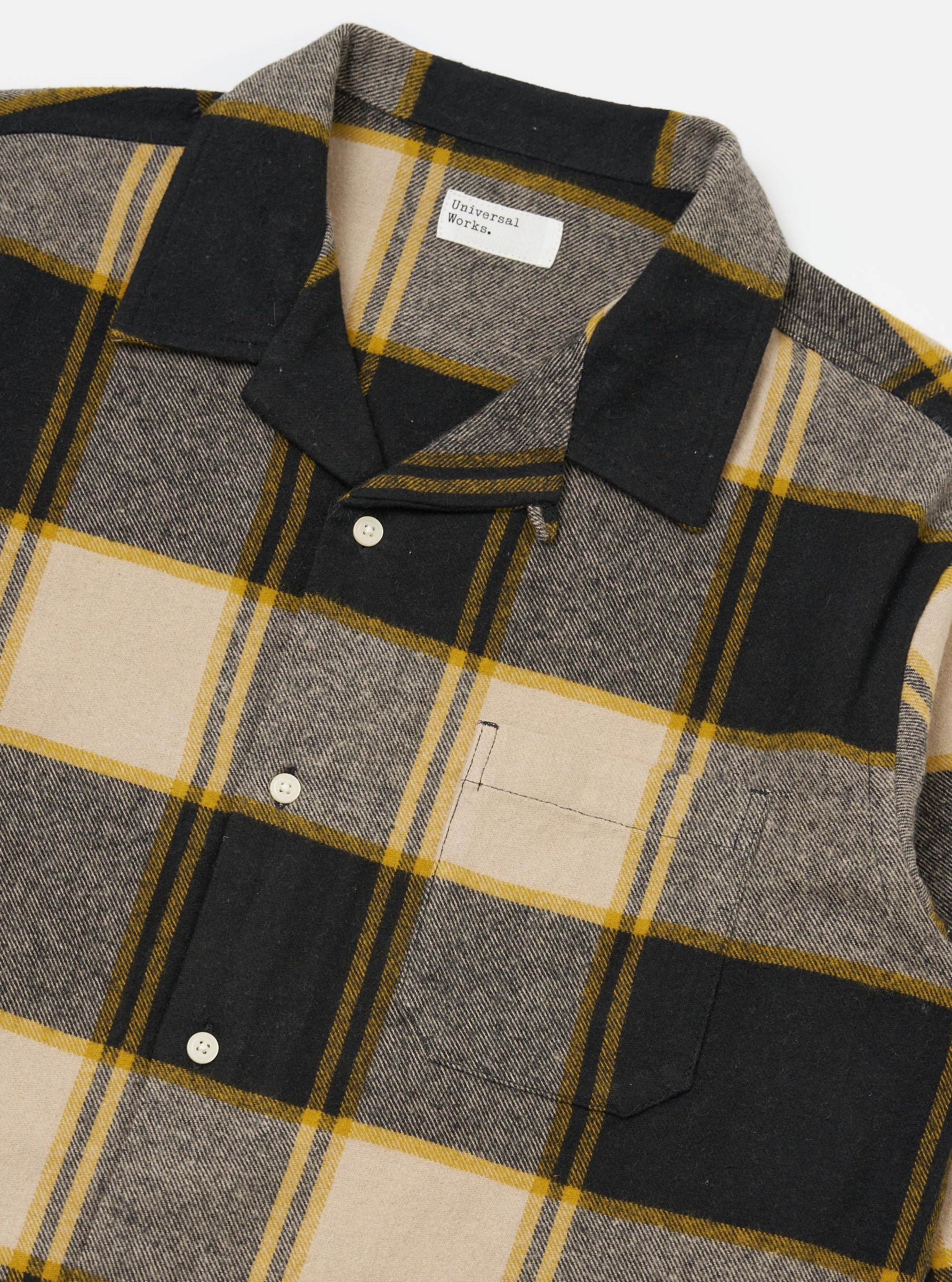 Close-up of the Black/Sand Brushed Big Check Long Pyjama Set top, featuring a brushed texture, button-down style, and chest pocket, laid on a white surface.