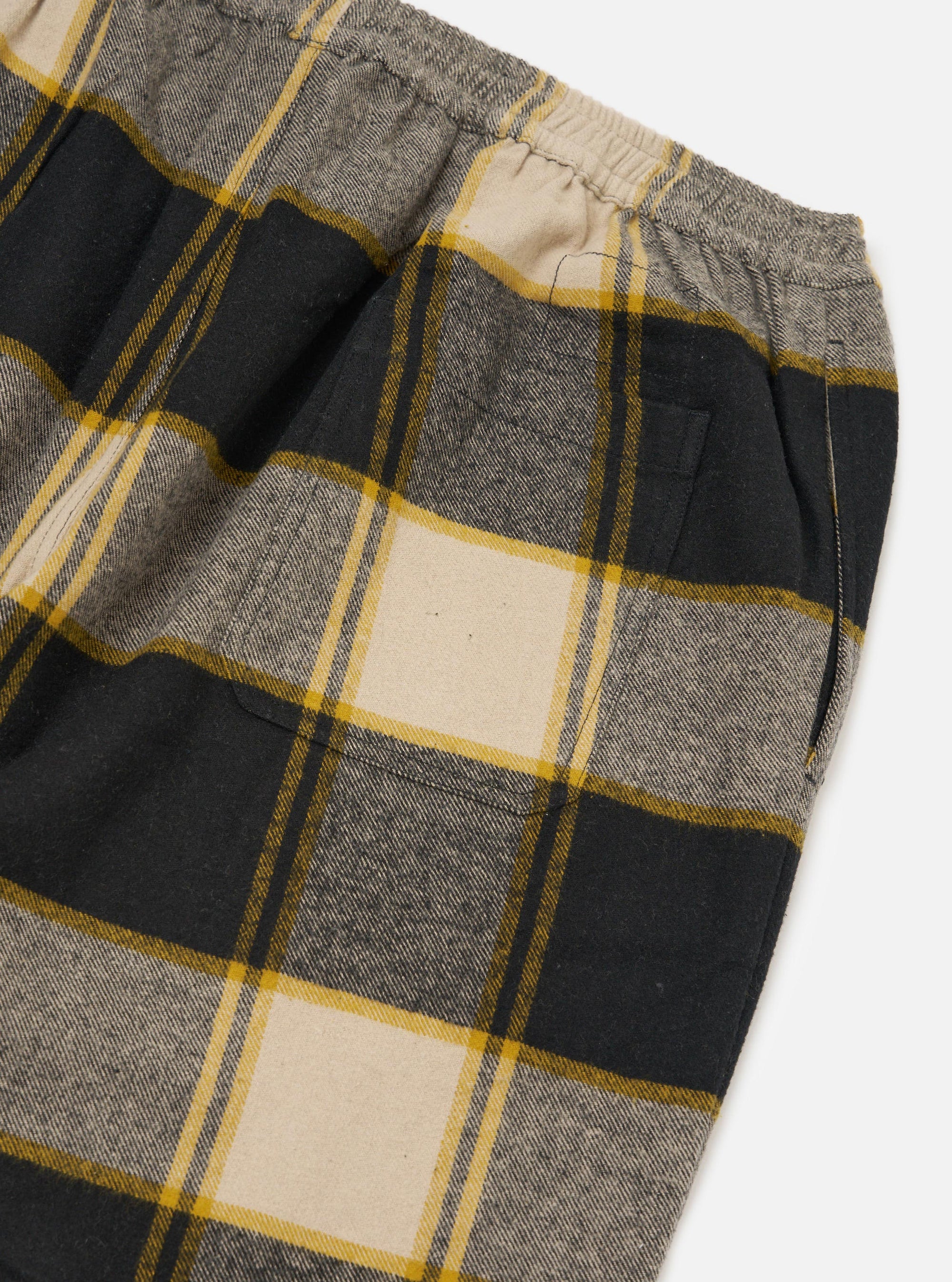 Close up of the Black/Sand Brushed Big Check Long Pyjama Set. Features a black, sand, and grey brushed check pattern with yellow stripes. Elastic waist. On a white background.