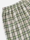 Close-up of the Green Busy Plaid Short Pyjama Set. The fabric is a soft plaid with green, beige, and black lines. The background is a plain white.