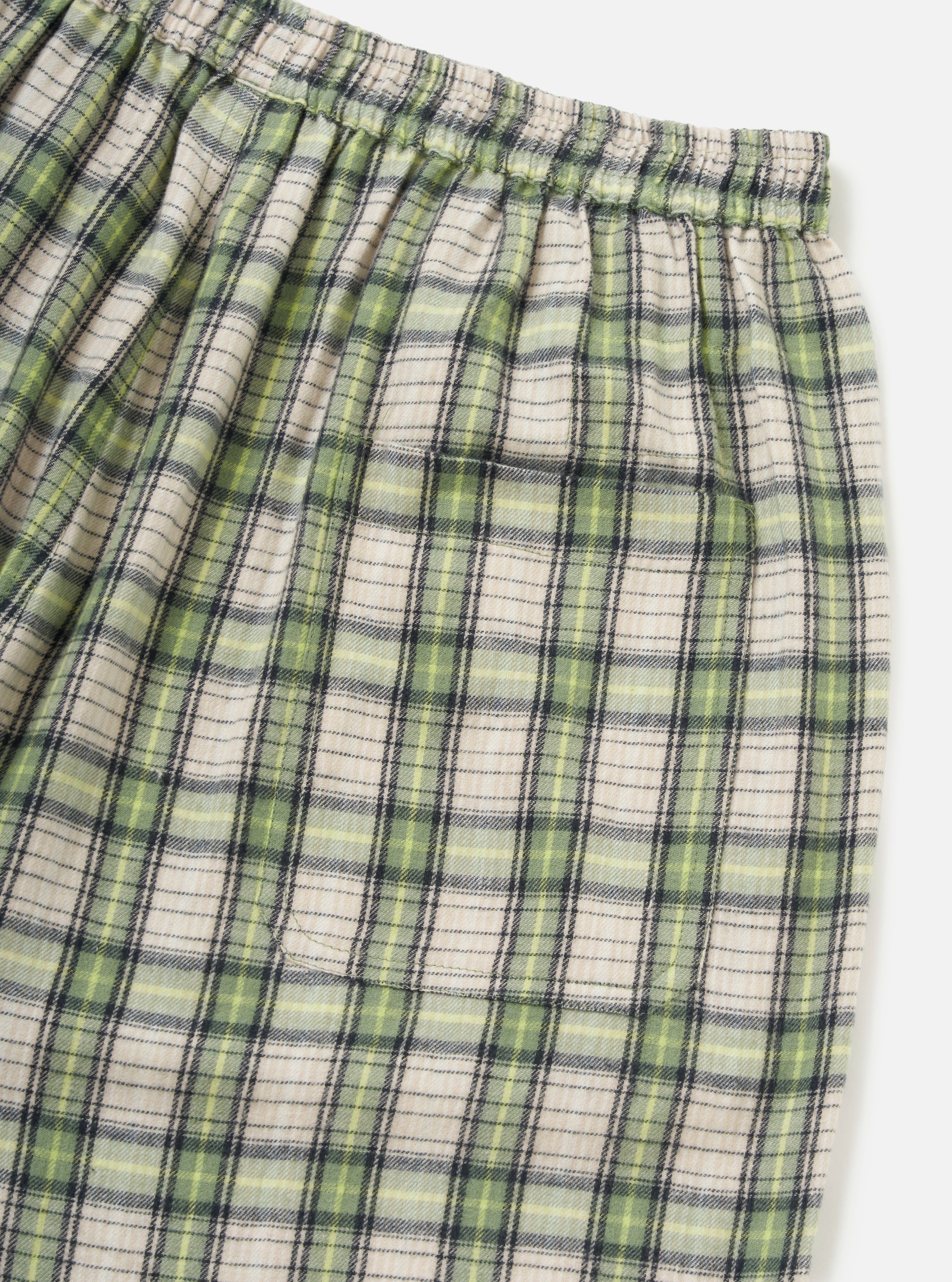 Close-up of the Green Busy Plaid Short Pyjama Set. The shorts feature a green, cream, and black plaid pattern with an elastic waistband, on a white background.