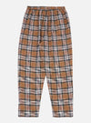 Close-up of the Brown Ikat Twill Check Long Pyjama Set pants on a white background. The brown, black, and white plaid twill fabric has a relaxed fit.