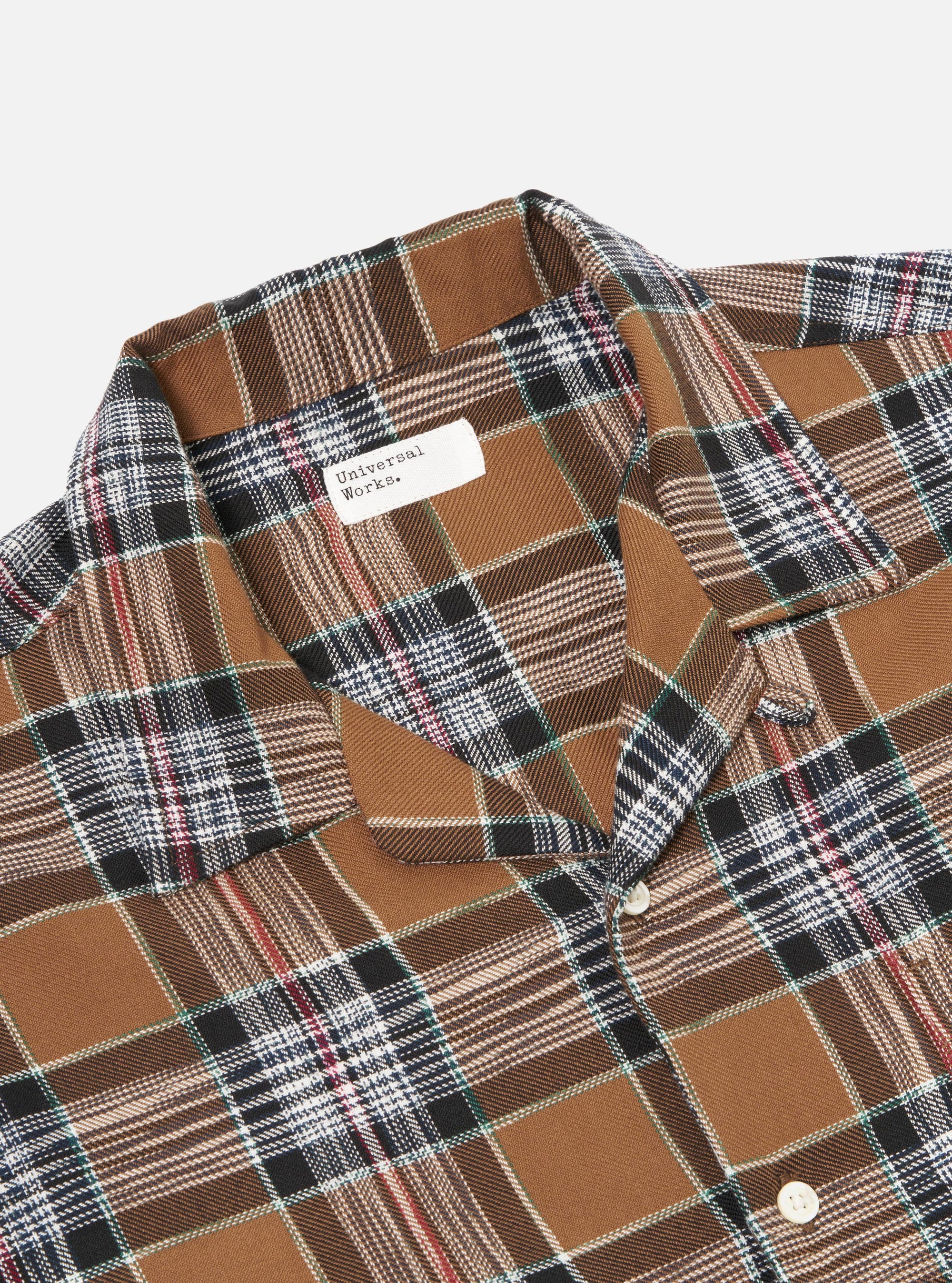Close-up of the Brown Ikat Twill Check Long Pyjama Set. Features a brown, black, white, and red plaid pattern. The set is displayed on a flat surface with a white background.
