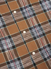 Close up of the brown ikat twill check long pyjama set. The fabric is a brown, black, white and red check with white buttons.