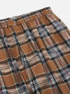 Close-up of the Brown Ikat Twill Check Long Pyjama Set. The brown, black, white, and red plaid twill fabric is visible. Elastic waistband. Shot on a white background.