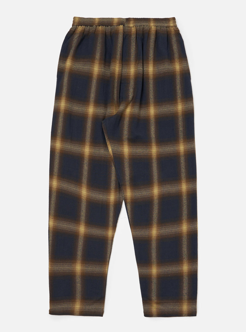 The Navy Canyon Check Pyjama Pant on a white background. The pants have a navy and tan check pattern and an elastic waist. The fit is relaxed.