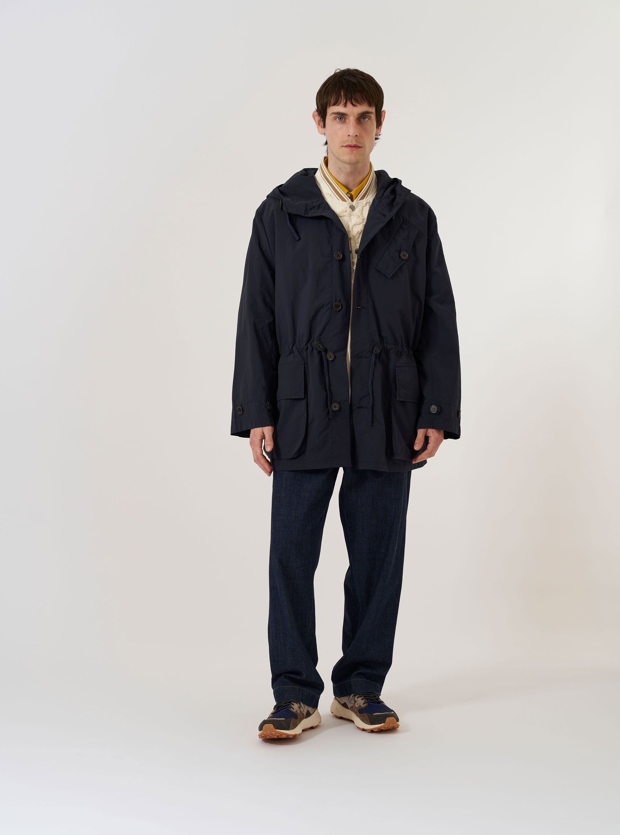 The Navy Seo Recycled Nylon Boston Parka is shown as a flat lay against a plain white background. The parka features a full-zip front with a buttoned storm flap, two large angled chest pockets, and two large lower patch pockets with flap closures. It has a high neck with a toggle-adjustable hood and adjustable button cuffs.