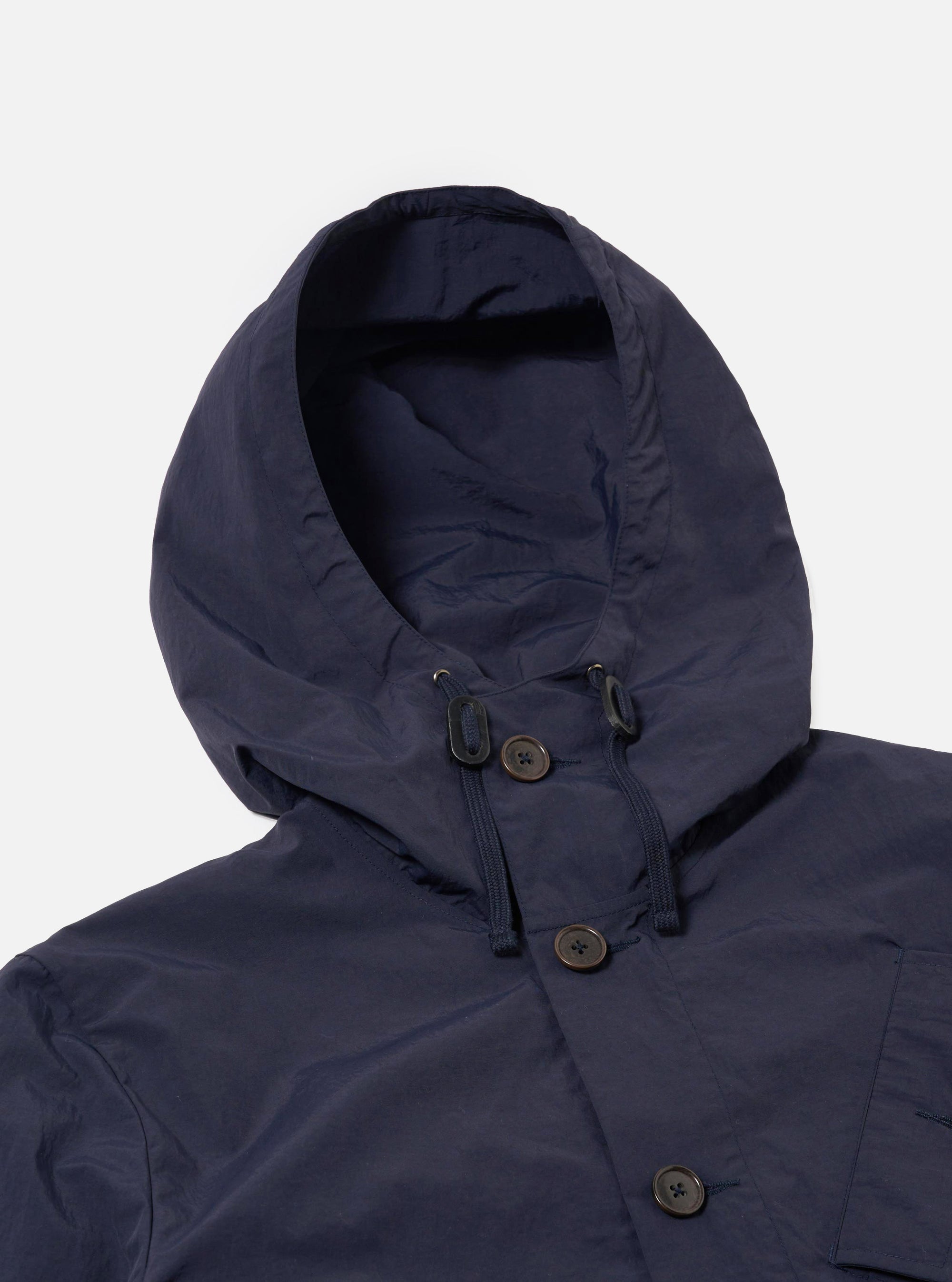 The Navy Seo Recycled Nylon Boston Parka is shown from a rear angle as a flat lay against a plain white background. The image highlights the clean construction of the back panel, the adjustable hood, and the smooth texture of the navy blue recycled nylon fabric.