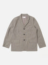 The Grey Brown Wales Glen Check Barra Jacket is shown as a flat lay against a white background. The jacket features a classic glen check pattern in shades of grey and brown, a three-button front closure, and two large patch pockets at the waist. The garment has a structured collar and a simple, clean design.