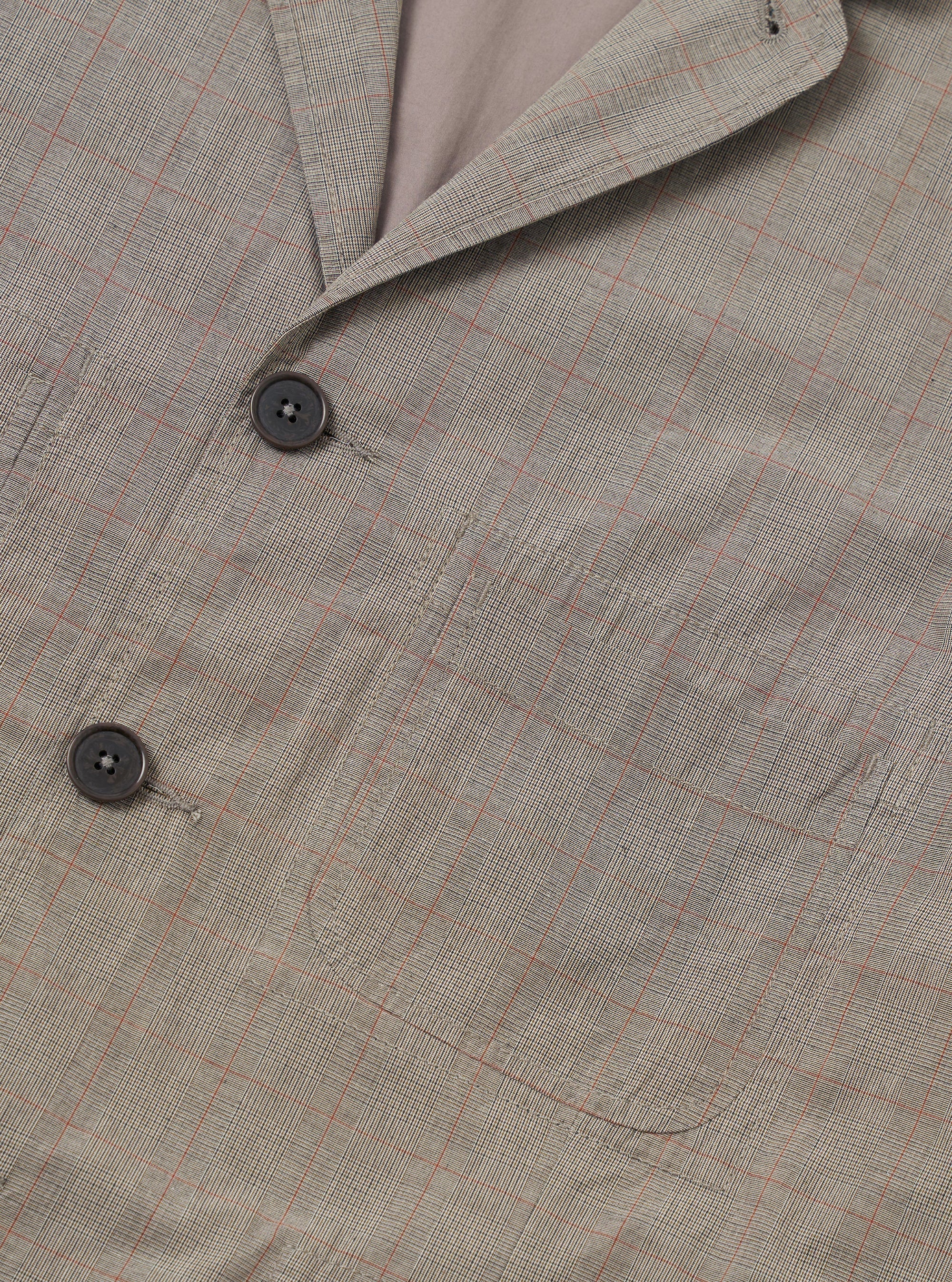The Grey Brown Wales Glen Check Barra Jacket is presented from the back as a flat lay against a plain white background. The jacket features a classic glen check pattern in grey and brown tones, with a central back seam and a single vent at the bottom hem.
