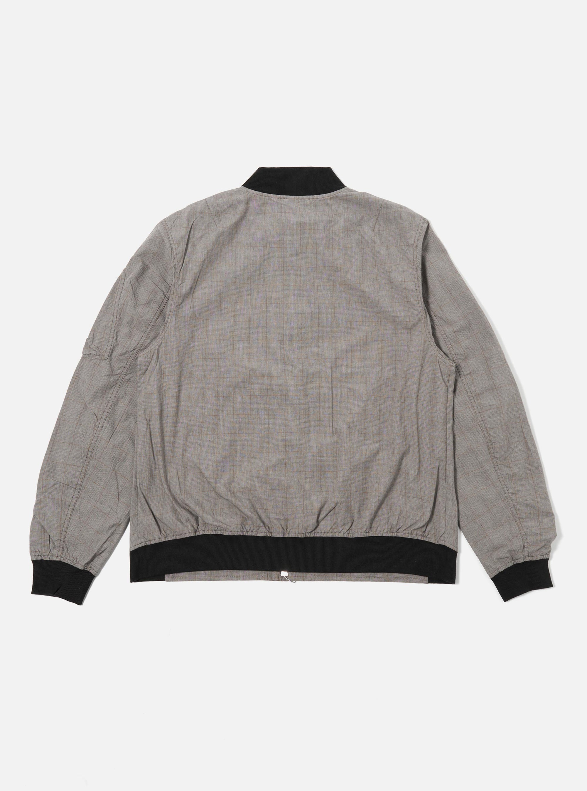 The Grey Brown Wales Glen Check NS Bomber Jacket is shown from the back as a flat lay against a white background. The jacket features a prominent glen check pattern in shades of grey and brown, with a ribbed collar, ribbed hem, and set-in sleeves.