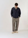 The Navy Peached Poplin NS Bomber Jacket is shown as a flat lay against a white background. The jacket features a central two-way zip front closure with visible metal pop studs, contrast stripe ribbing on the collar and cuffs, and large hand warmer pockets. A zipped utility stash pocket is visible on the sleeve, and the garment is constructed with articulated sleeves.