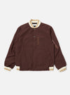 The Brown Peached Poplin NS Bomber Jacket is shown as a flat lay against a plain white background. The jacket features a central zip-front closure, two slanted welt pockets at the waist, and tonal ribbed detailing at the collar, cuffs, and hem. The cotton peached poplin fabric has a smooth, matte finish in a solid brown color.