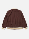 The Brown Peached Poplin NS Bomber Jacket is shown from the back as a flat lay against a plain white background. The image highlights the smooth, matte texture of the brown cotton poplin fabric and the simple construction of the garment's rear panel, including a visible ribbed collar and hem.