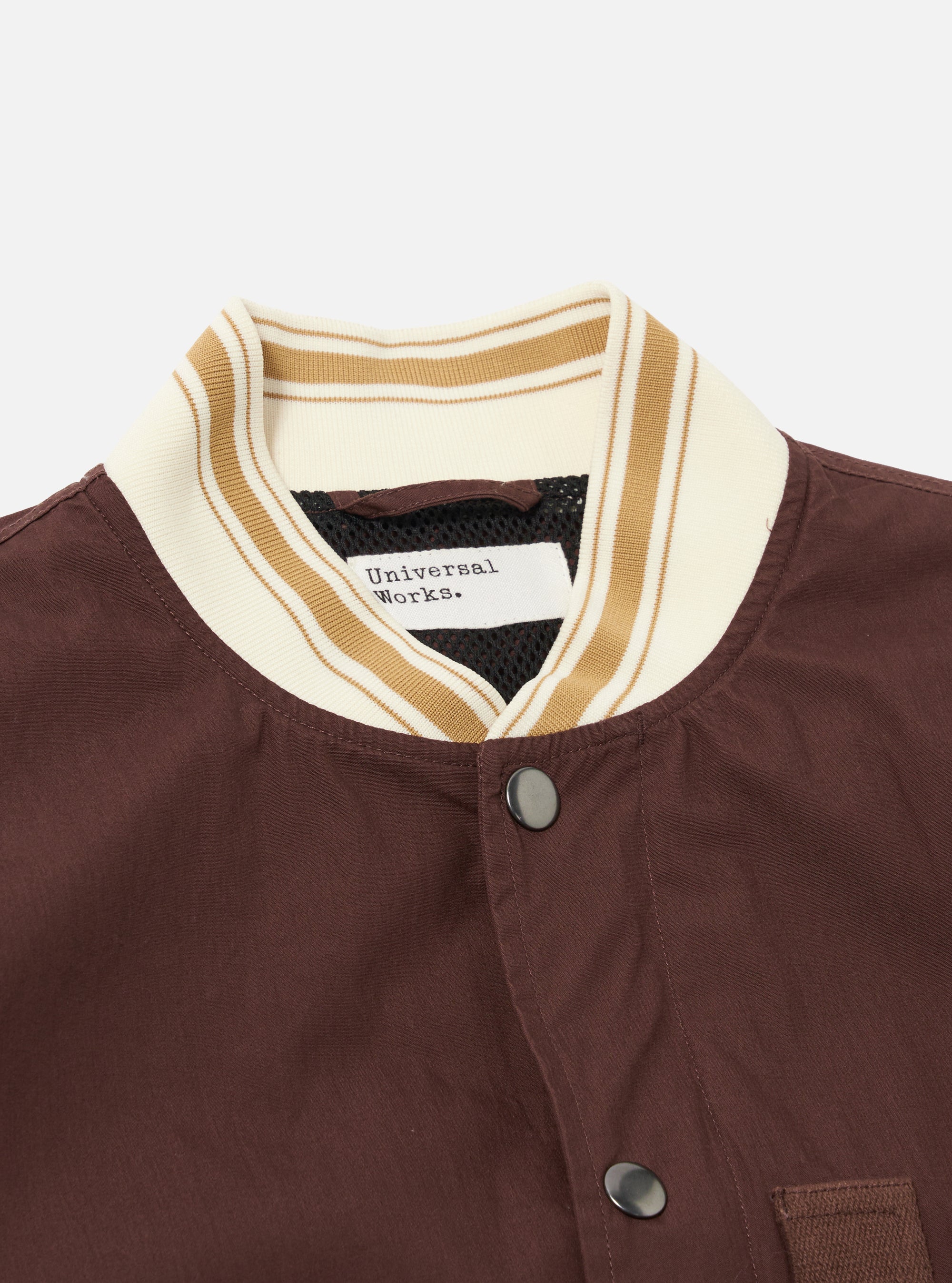 The Brown Peached Poplin NS Bomber Jacket is shown from the back as a flat lay against a plain white background. The image highlights the smooth brown cotton fabric, a simple straight hem, and clean construction lines across the shoulders and back panel.