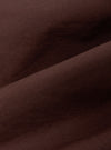 A close-up fabric swatch of the Brown Peached Poplin NS Bomber Jacket highlights the smooth, matte texture and rich brown color of the peached poplin material. The fabric fills the frame, providing a detailed view of the garment's weave and solid color.