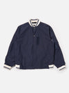 The Navy Peached Poplin NS Bomber Jacket is shown as a flat lay against a plain white background. The jacket features a central front closure with a partially concealed two-way zip and metal pop studs, contrast stripe ribbing at the collar and cuffs, and two large hand warmer pockets. The smooth navy cotton fabric has a matte, peached finish.