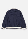 The Navy Peached Poplin NS Bomber Jacket is shown from the back as a flat lay against a plain white background. The image highlights the jacket's smooth navy blue fabric, a simple one-piece back panel, and tonal ribbed detailing at the collar, cuffs, and hem.