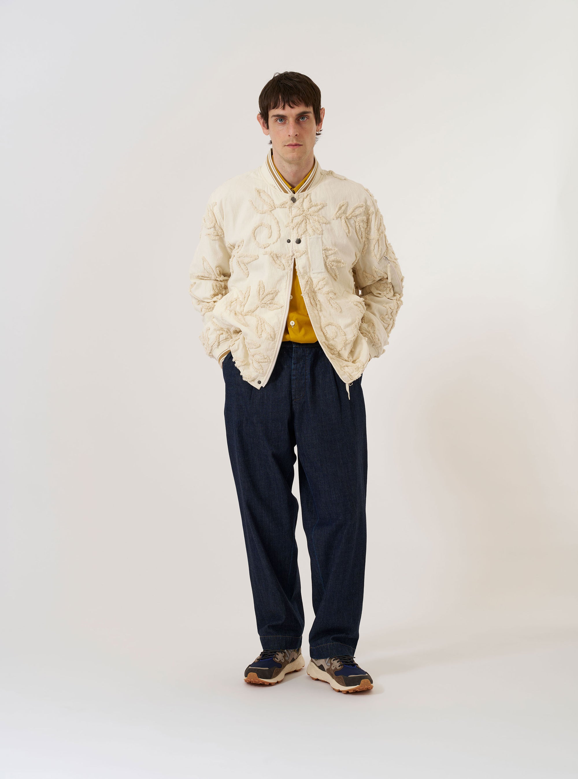 The Ecru 3D Flower NS Bomber Jacket is shown as a flat lay against a plain white background. The jacket features an all-over textured 3D floral pattern, a ribbed collar, matching ribbed cuffs and hem, and a central front closure.