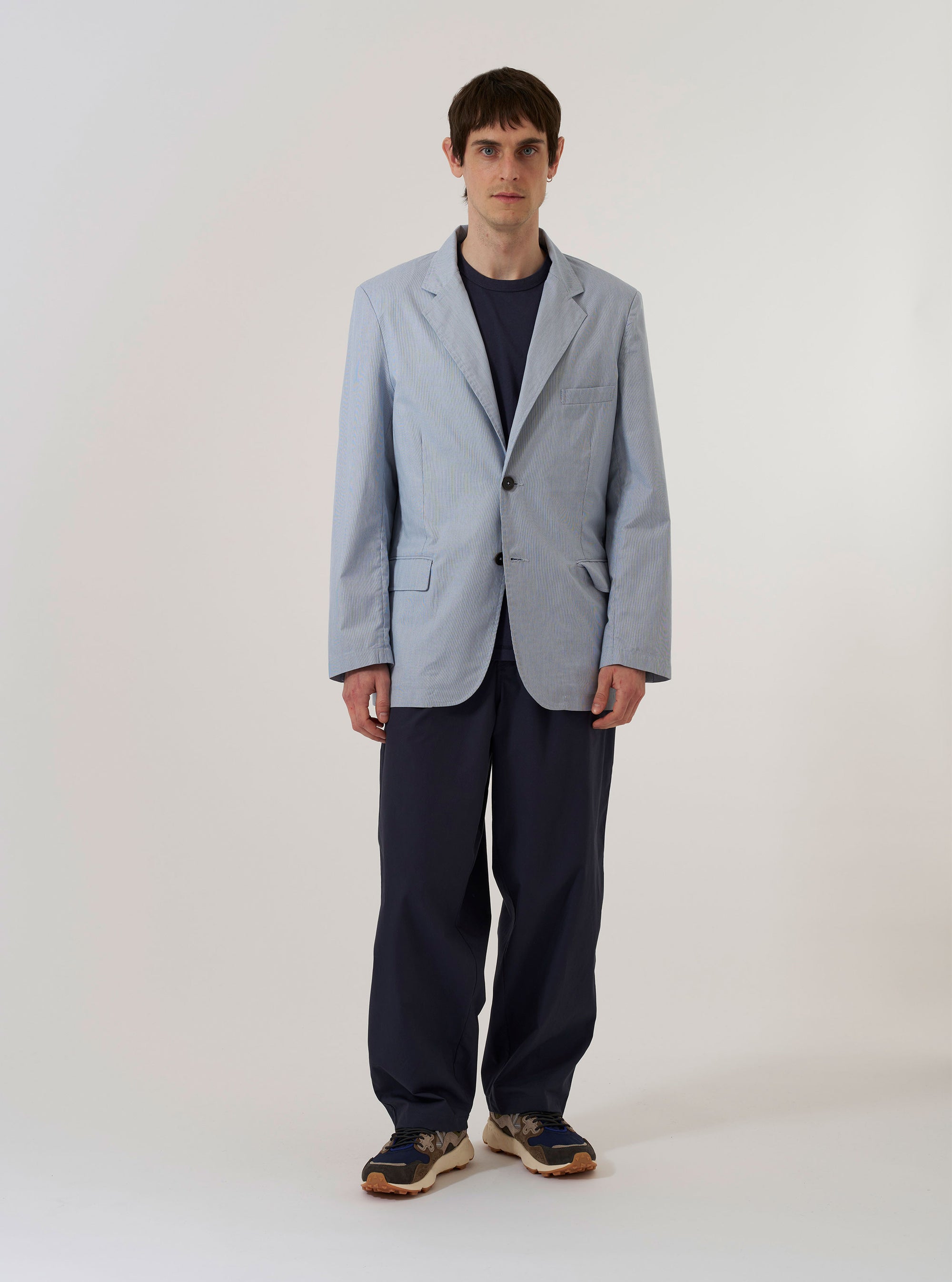 The Navy Kennedy Stripe Boston Blazer is shown as a flat lay against a white background. The blazer features a subtle vertical pinstripe pattern, a three-button front closure, notched lapels, two large flap pockets at the waist, and a single welt pocket on the chest.